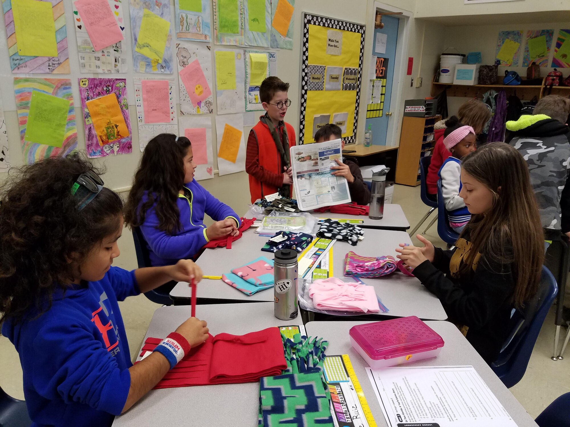 Ms. Kelly's fifth-grade class from Branch Elementary put the finishing touches on handmade fleece scarves. The students made approximately 150 scarves and, along with donated gloves, gave them to the local homeless shelter. (Courtesy photo)