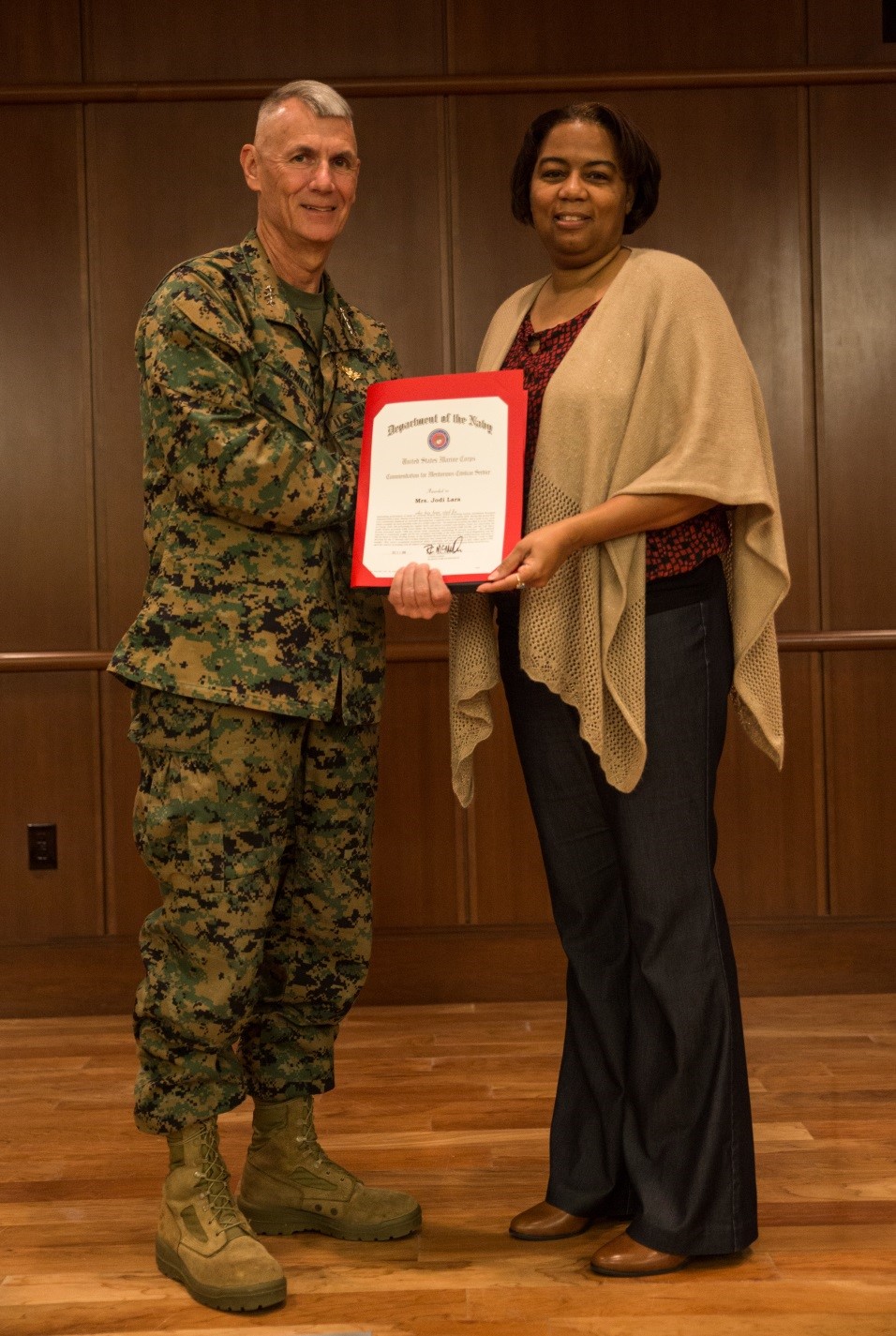 Lt. Gen. Rex C. McMillian, commander of Marine Forces Reserve and Marine Forces North, presents Jodi M. Lara, assistant officer in charge of the orders processing section, Installation Personnel Administration Center, with the 2016 Junior Civilian of the Year award at Marine Corps Support Facility New Orleans, Jan. 4, 2017. Lara was recognized for the remarkable support she has provided to the Marines, as well as for going above and beyond her everyday job duties.