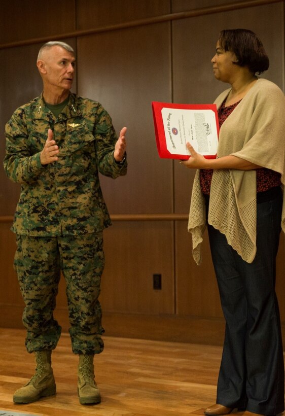 Lt. Gen. Rex C. McMillian, commander of Marine Forces Reserve and Marine Forces North, recognizes the accomplishments of Jodi M. Lara, assistant officer in charge of the orders processing section, Installation Personnel Administration Center, at Marine Corps Support Facility New Orleans, Jan. 4, 2017. Lara was presented the 2016 Junior Civilian of the Year award for the dedication she has provided to the Marines and for going above and beyond in her daily job duties. (U.S. Marine Corps photo by Cpl. Melissa Martens/ Released) 