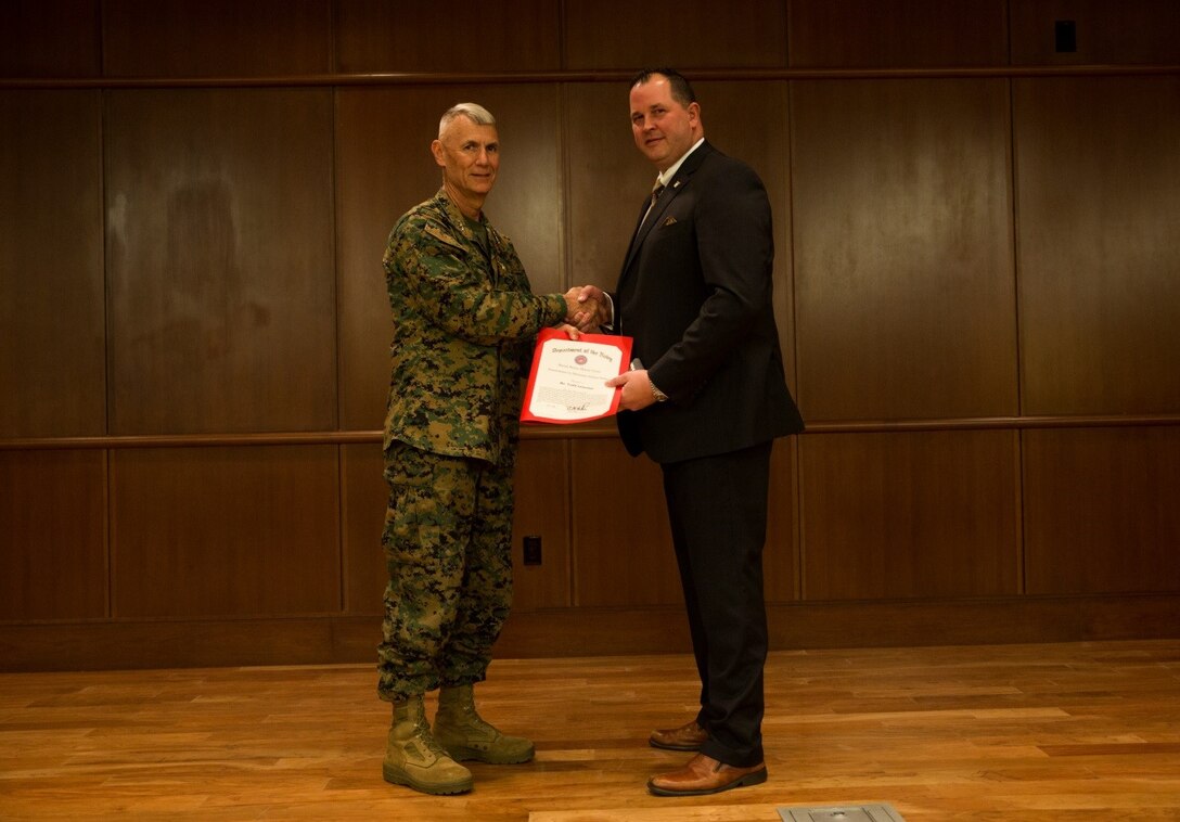 Lt. Gen. Rex C. McMillian, commander of Marine Forces Reserve and Marine Forces North, presents Todd Lemoine, director of mission assurance for MARFORRES, with the 2016 Senior Civilian of the Year award at Marine Corps Support Facility New Orleans, Jan. 4, 2017. Lemoine was recognized for the critical role he played throughout the year at MARFORRES in achieving mission accomplishment. (U.S. Marine Corps photo by Cpl. Melissa Martens/ Released)