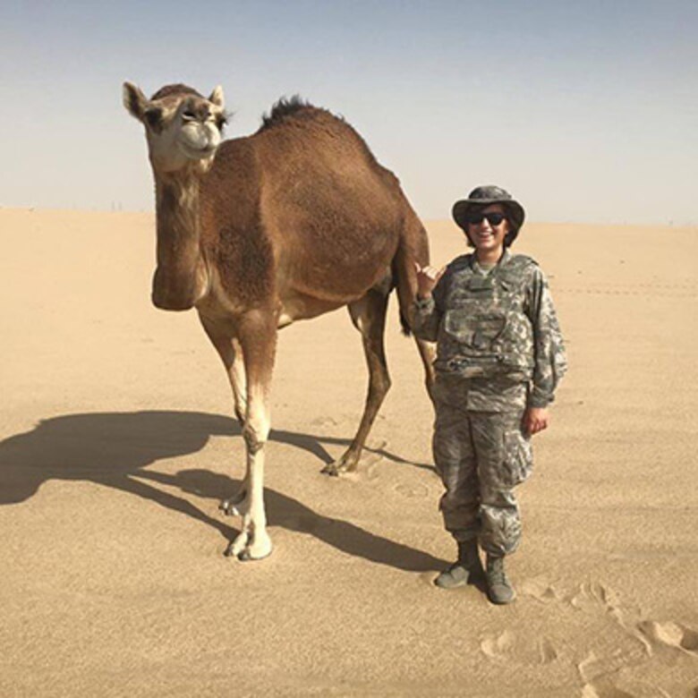 Cadet 1st Class Cinthya Elizondo-Gamez stands next to a camel during her Air Force Operations trip to Kuwait in 2016. (Courtesy photo)