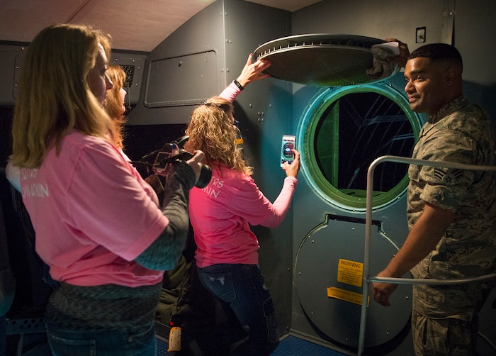 Senior Airman Rikel Cifre, 433rd Aircraft Maintenance Squadron crew chief, opens the tail hatch during a C-5M Super Galaxy aircraft tour for the Air Force Wing Moms Jan. 5, 2017 at Joint Base San Antonio-Lackland,Texas. The AFWM's mission is to provide support to family members and friends of trainees who are  experiencing Air Force Basic Military Training. (U.S. Air Force photo by Benjamin Faske)