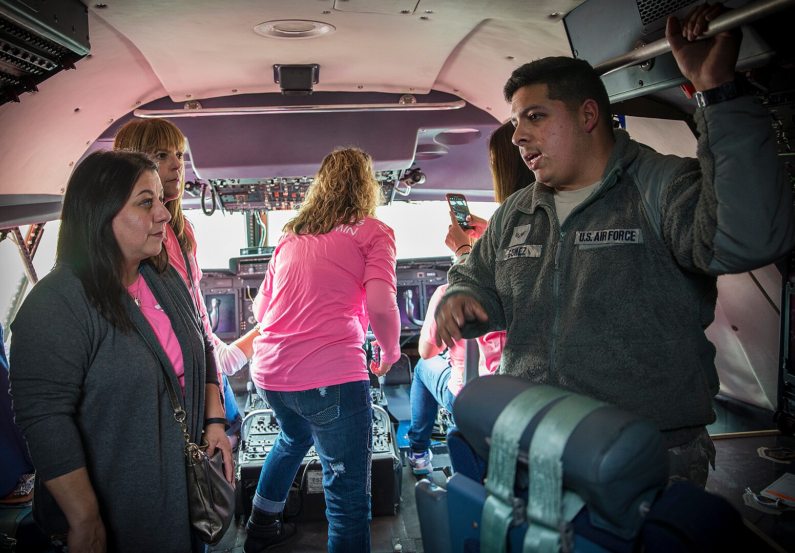 Senior Airman Rolando Gomez, 433rd Aircraft Maintenance Squadron hydrolic technician, explains his job to Lisa Haar, Air Force Wing Moms founder, during a C-5M Super Galaxy tour Jan. 5, 2017 at Joint Base San Antonio-Lackland,Texas. The AFWM's mission is to provide support to family members and friends of trainees who are  experiencing Air Force Basic Military Training. (U.S. Air Force photo by Benjamin Faske)