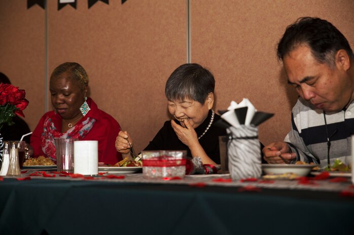 Hitomi Yamaguchi, a logistics-contractor specialist, laughs and reminisces with her friends at her retirement ceremony at Marine Corps Air Station Iwakuni, Japan, Dec. 16, 2016. Yamaguchi started working on the air station in 1974 and held four jobs during her 42 years of service as a stock control clerk, voucher examiner, and an administrator specialist.  However, she spent most of her time as a logistics-contractor specialist.   (U.S. Marine Corps photo by Lance Cpl. Gabriela Garcia-Herrera)