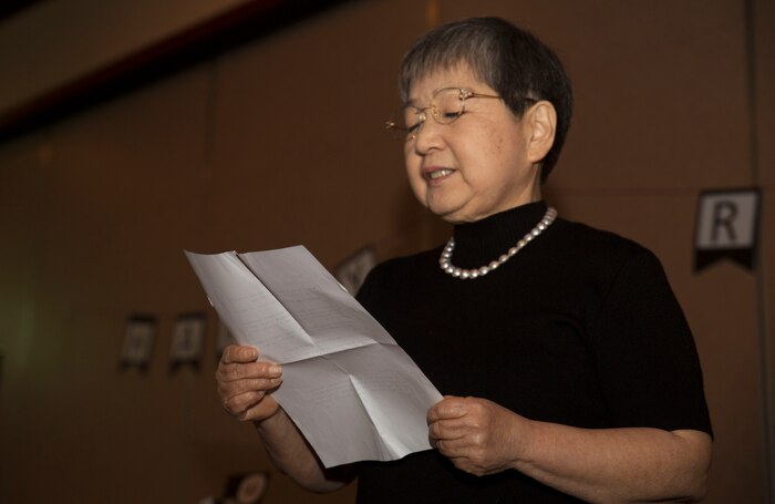 Hitomi Yamaguchi, a logistics-contractor specialist, reads a thank-you note she wrote to her guests during her retirement ceremony at Marine Corps Air Station Iwakuni, Japan, Dec. 16, 2016. Yamaguchi started working at the air station in 1974 and held four jobs during her 42 years of as a stock control clerk, a voucher examiner, and an administrator specialist. However, she spent most of her time as a logistics-contractor specialist. (U.S. Marine Corps photo by Lance Cpl. Gabriela Garcia-Herrera)