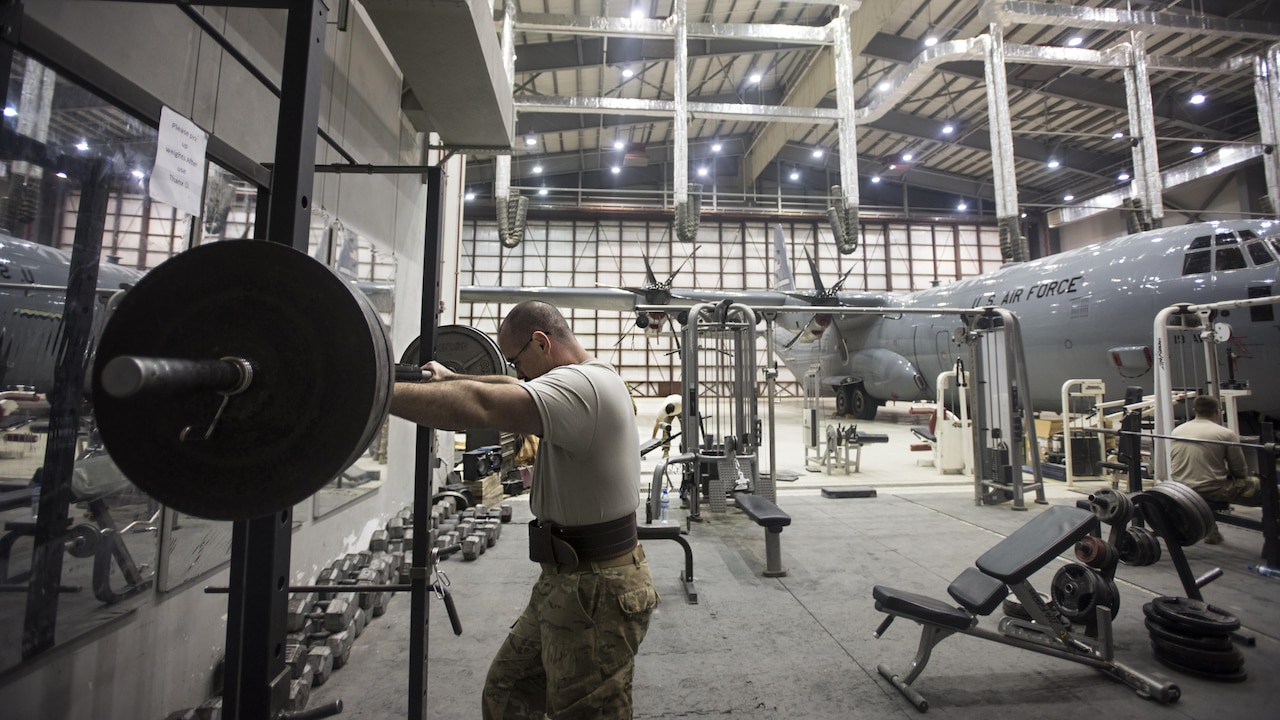 Tech. Sgt. Jason Caswell, 455th Expeditionary Aircraft Maintenance Squadron C-130 Hercules debrief NCO-in-charge, prepares to lift weights Jan. 4, 2016 at Bagram Airfield, Afghanistan. Caswell is a wounded warrior deployed on his second back-to-back tour, his first time downrange since losing a leg to a sports injury. (U.S. Air Force photo by Staff Sgt. Katherine Spessa)