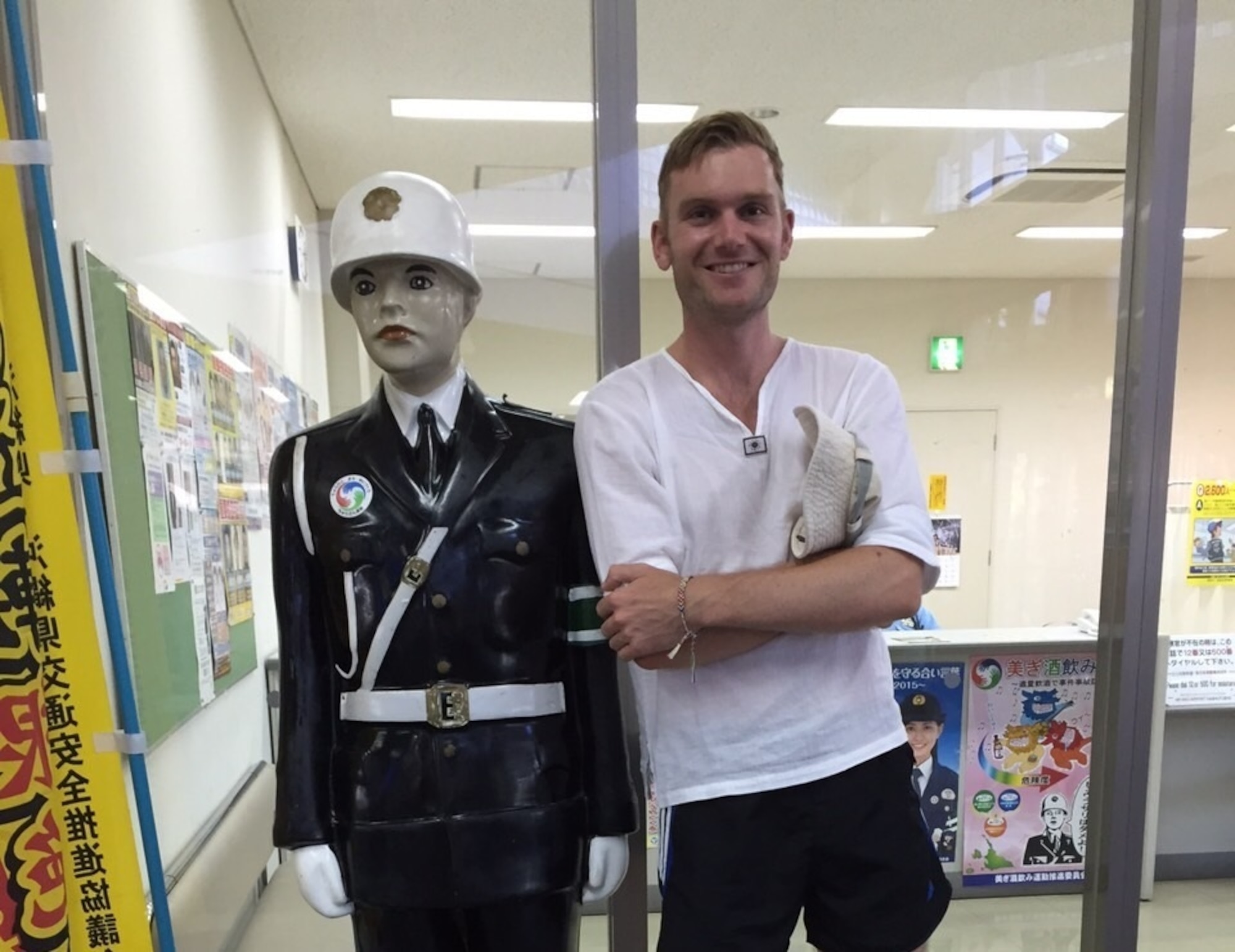 Mamoru-Kun and Senior Airman John Linzmeier, 18th Wing Public Affairs photojournalist journeyman, snap a picture together before parting ways July 27, 2015, at the Miyako-Jima Airport, Okinawa, Japan. Many replicas of the statue are posted around the island and have helped encourage locals and visitors like myself to make conscious decisions about driving. (courtesy photo)