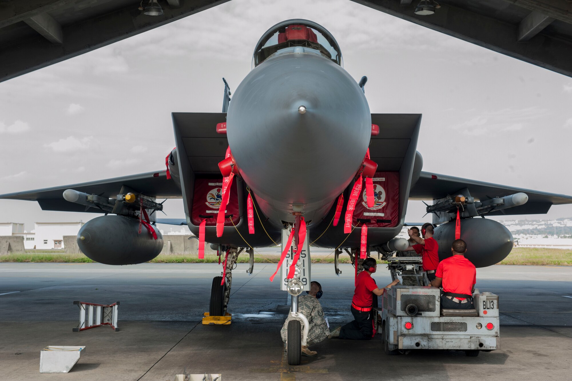 U.S. Air Force Airmen from the 67th Aircraft Maintenance Unit load an AIM-120 Advanced Medium Range Air-to-Air Missile onto an F-15 Eagle Jan. 4, 2017, at Kadena Air Base, Japan. Weapons load crew members have to rush against the clock while using proper loading procedures to ensure secure connections of the missiles onto the F-15 Eagle. (U.S. Air Force photo by Senior Airman Lynette M. Rolen/Released)