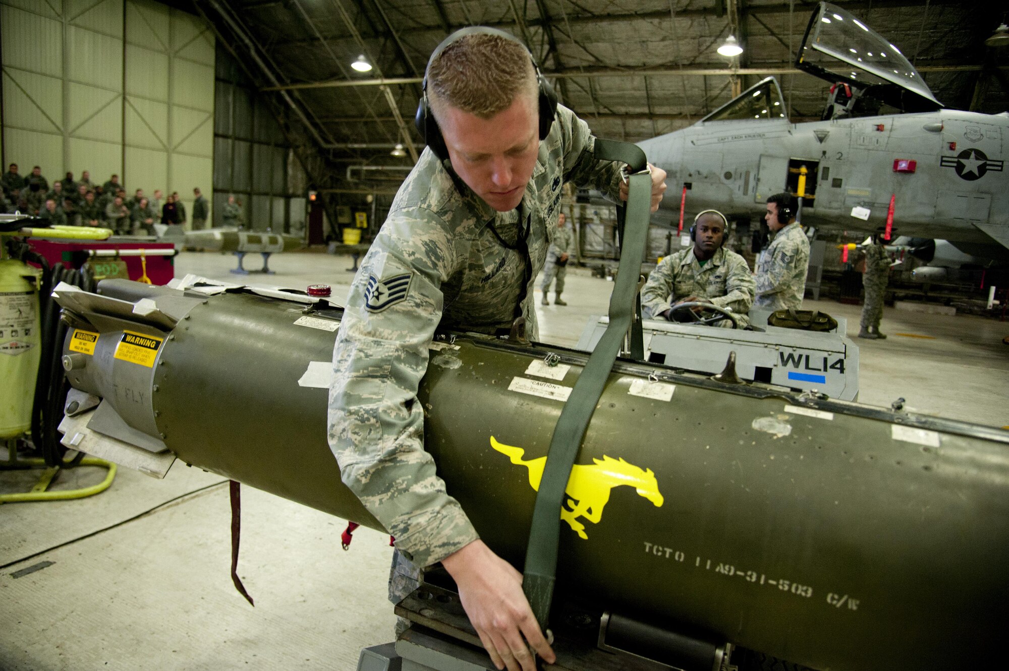U.S. Air Force Staff Sgt. Michael Hillard, 25th Aircraft Maintenance Unit weapons load crew chief, and Senior Airman Michael Smith 25th AMU weapons load crewmember, load a CBU-103 bomb onto a weapons loader during a weapons load competition on Osan Air Base, Republic of Korea, Jan. 6, 2017. The best weapons load crew from the 25th and 36th AMUs battle it out every quarter to see which unit can reload munitions on their respective aircraft the quickest and safest. (U.S. Air Force photo by Staff Sgt. Jonathan Steffen)