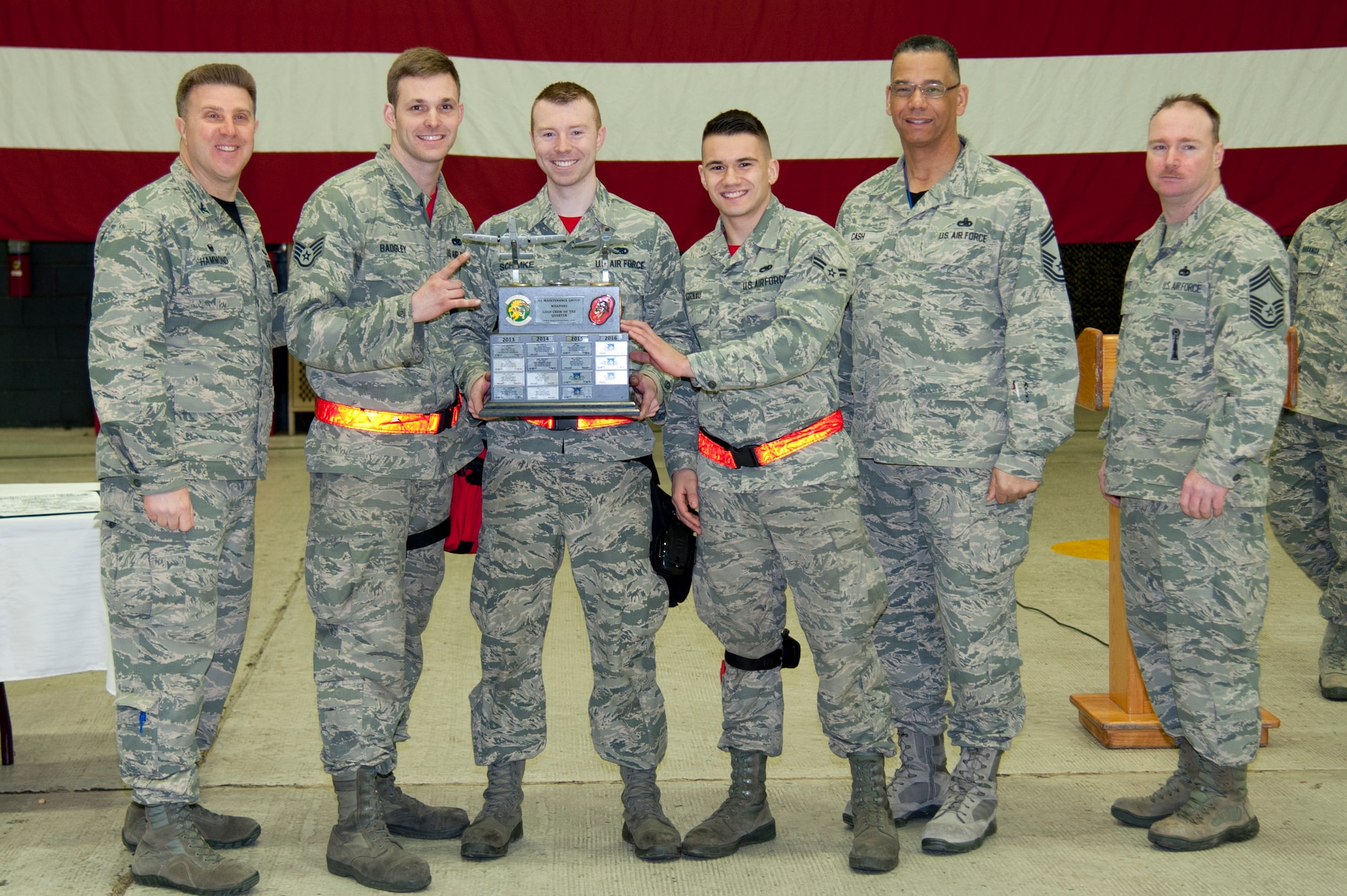 Leadership from the 51st Maintenance Group present the 4th Quarter Weapons Load Crew of the Quarter Award to Staff Sgt. Adam Badgley, Staff Sgt. Christopher Schimke and Airman 1st Class Niko Kornau at Osan Air Base, Republic of Korea, Jan. 6, 2017. The 36th Aircraft Maintenance Unit won the award for reloading munitions on their respective aircraft the quickest and safest. (U.S. Air Force photo by Staff Sgt. Jonathan Steffen)