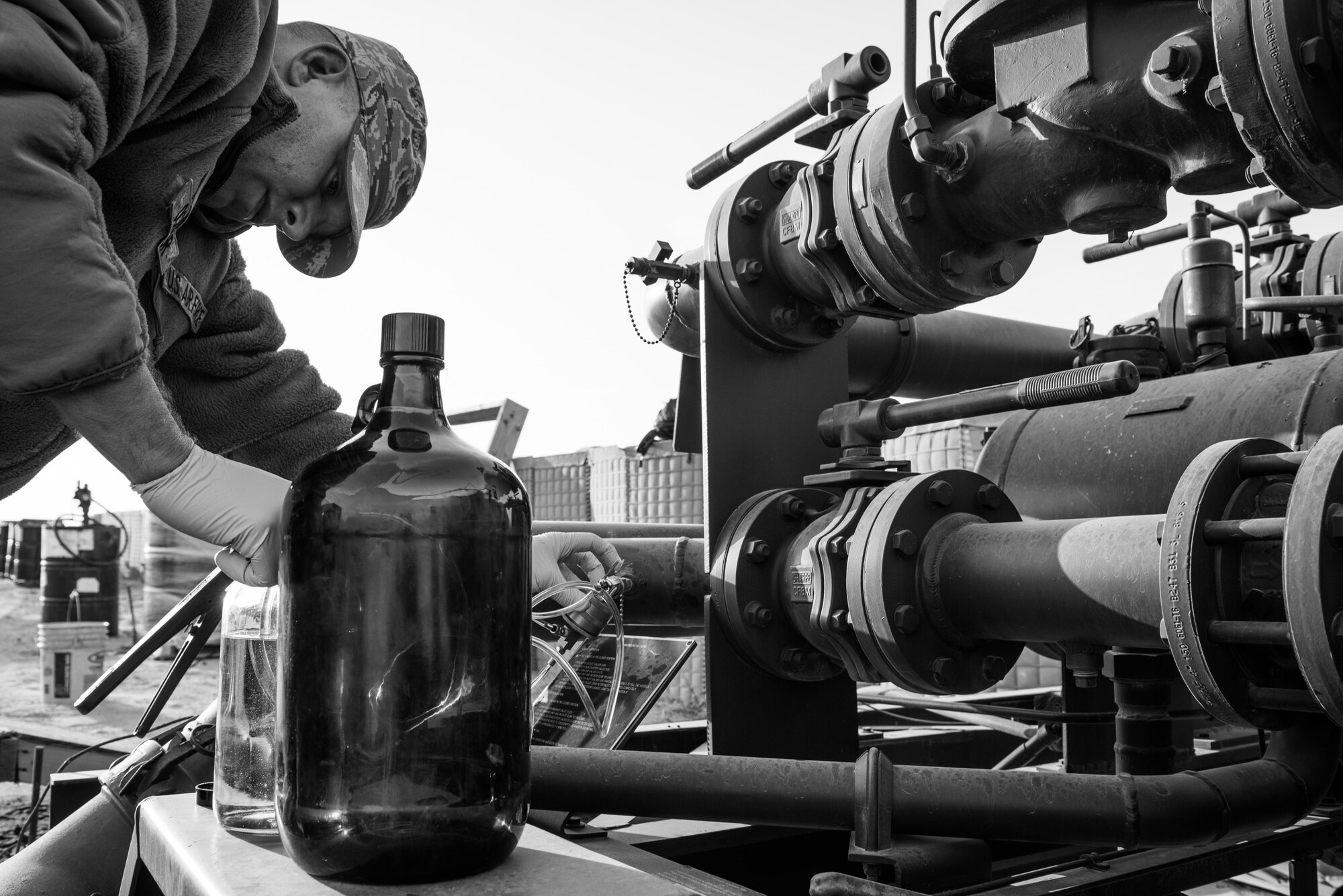Tech. Sgt. Brian O’Connor, 407th Expeditionary Logistics Readiness Squadron NCO in charge of fuels distribution, withdraws a sample from a fuel mix set up at the 407th Air Expeditionary Group, Jan. 2, 2017. The unit mixes additives with the jet fuel as it is delivered to the holding systems and samples are tested in a lab to ensure the correct ratio is present. (U.S. Air Force photo/Master Sgt. Benjamin Wilson)(Released)