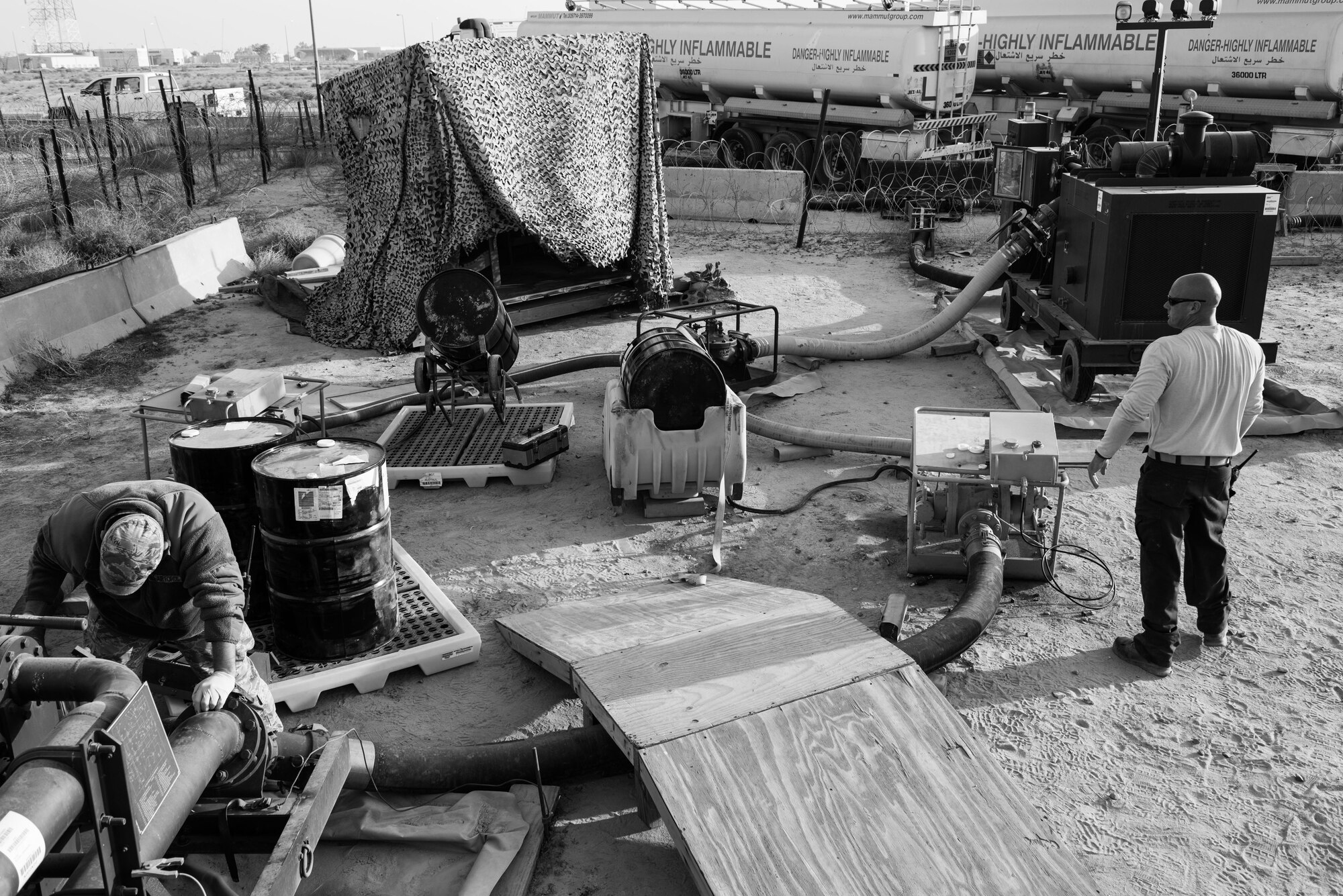 Tech. Sgt. Brian O’Connor, 407th Expeditionary Logistics Readiness Squadron NCO in charge of fuels distribution, (left) and Tech. Sgt. Timothy Haag, 407th ELRS NCO in charge of fuels fixed facilities, monitor a fuel mix set up at the 407th Air Expeditionary Group, Jan. 2, 2017. The unit saves more than $700,000 a year by mixing additives into the fuel upon delivery. (U.S. Air Force photo/Master Sgt. Benjamin Wilson)(Released)