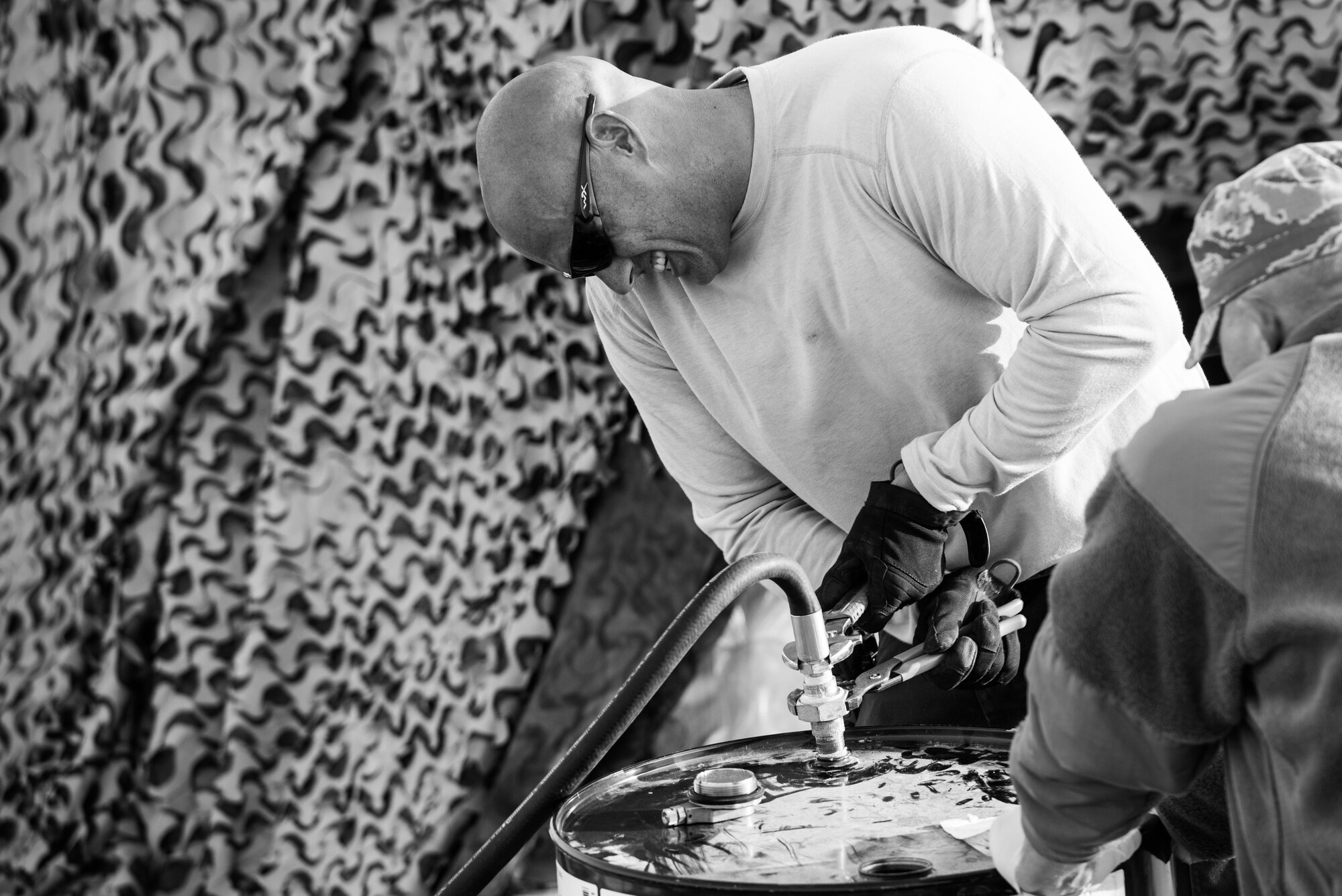 Tech. Sgt. Timothy Haag, 407th Expeditionary Logistics Readiness Squadron NCO in charge of fuels fixed facilities, changes a barrel fitting for a fuel mix system at the 407th Air Expeditionary Group, Jan. 2, 2017. Haag designed the system to mix additives with straight jet fuel to save the unit more than $700,000 a year. (U.S. Air Force photo/Master Sgt. Benjamin Wilson)(Released)