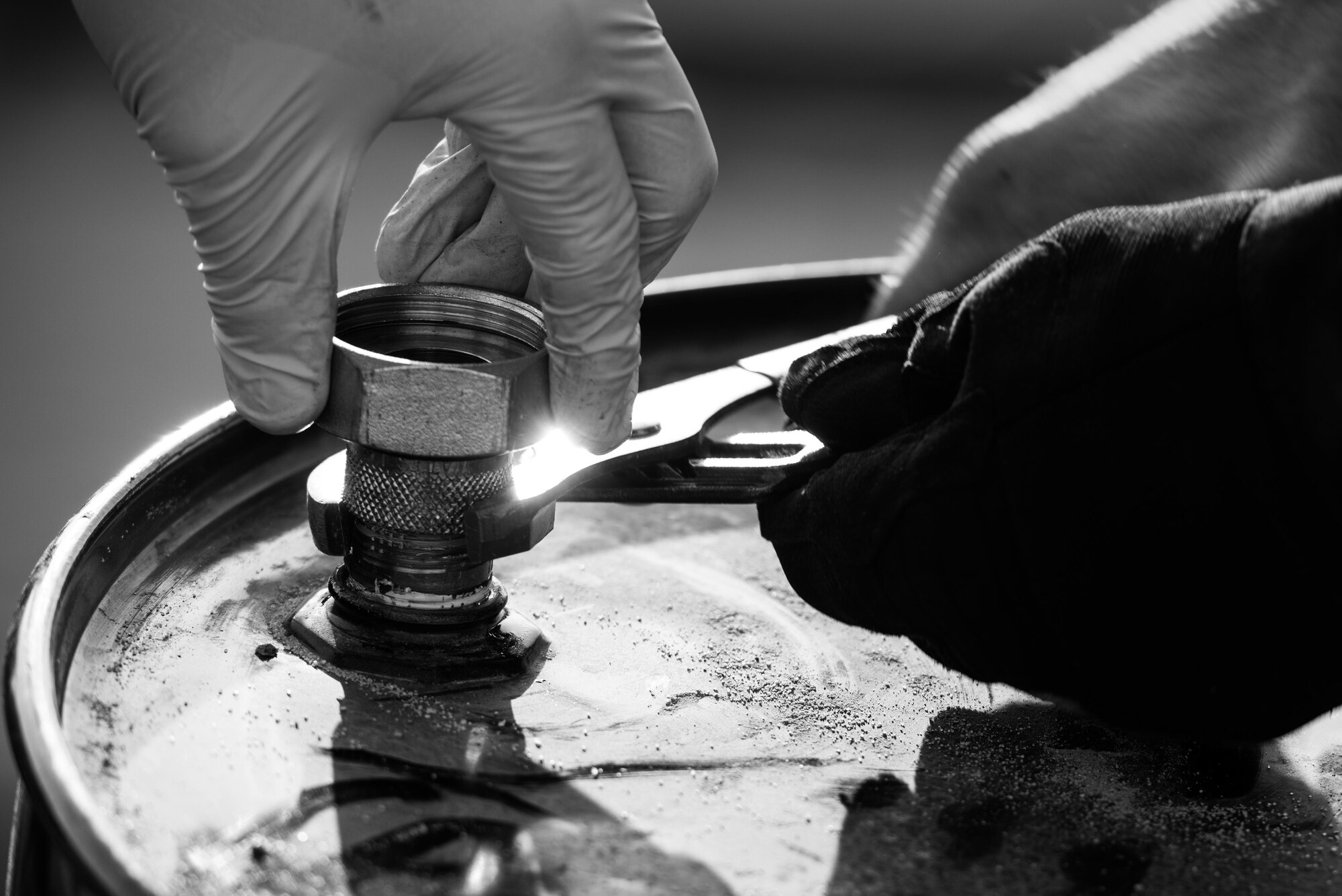 Tech. Sgt. Timothy Haag, 407th Expeditionary Logistics Readiness Squadron NCO in charge of fuels fixed facilities, changes a barrel fitting for a fuel mix system at the 407th Air Expeditionary Group, Jan. 2, 2017. Haag designed the system to mix additives with straight jet fuel to save the unit more than $700,000 a year. (U.S. Air Force photo/Master Sgt. Benjamin Wilson)(Released)
