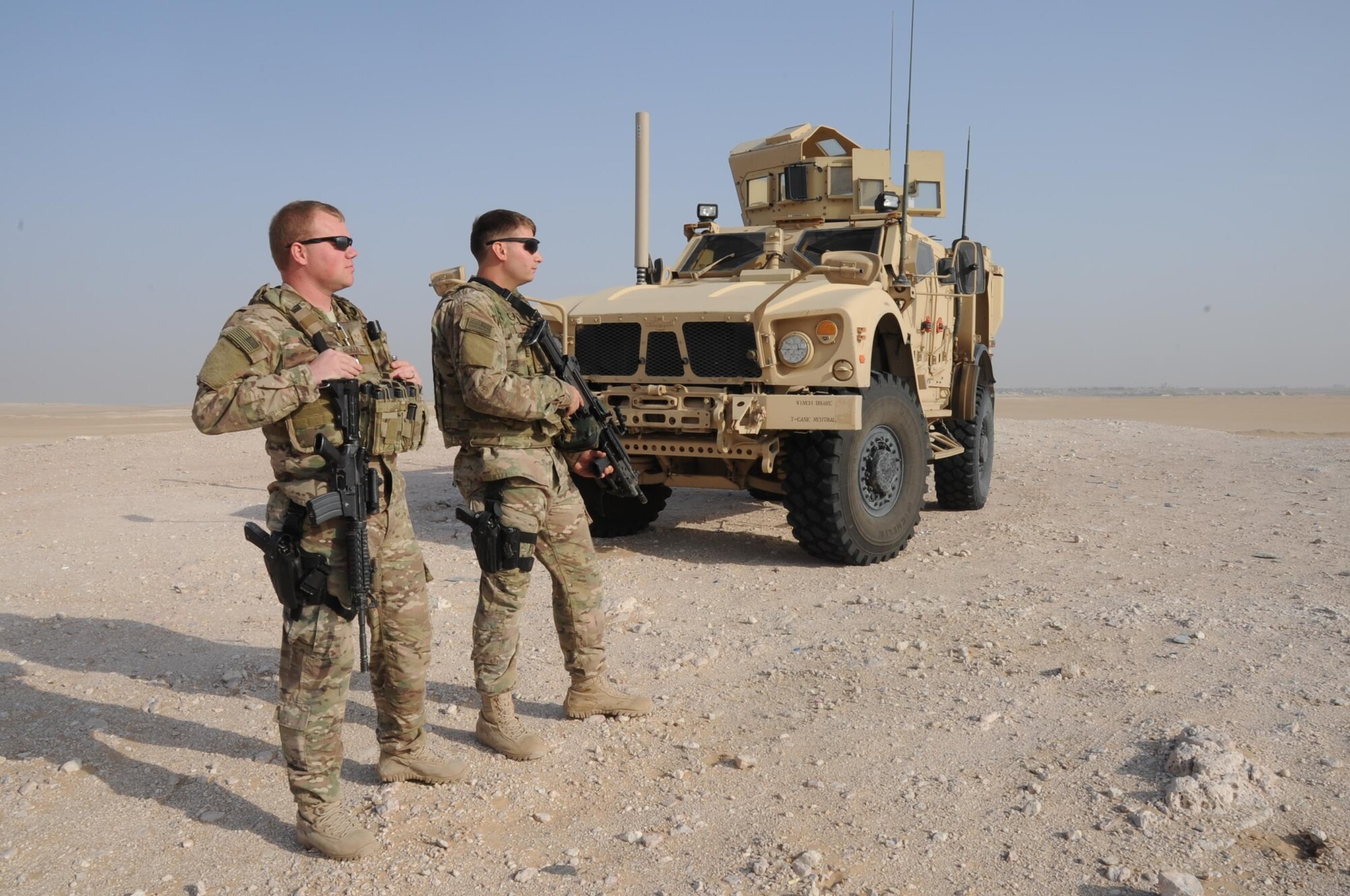Senior Airman Rhea Flambeau, left, and Senior Airman Grayson Bryant, right, 386th Expeditionary Security Forces Squadron patrolmen, guard the base security zone at an undisclosed location in Southwest Asia Jan. 1, 2016. Both Airmen are responsible for protecting the base and building positive relationships with local citizens within the surrounding camps. (U.S. Air Force photo/Tech. Sgt. Kenneth McCann)