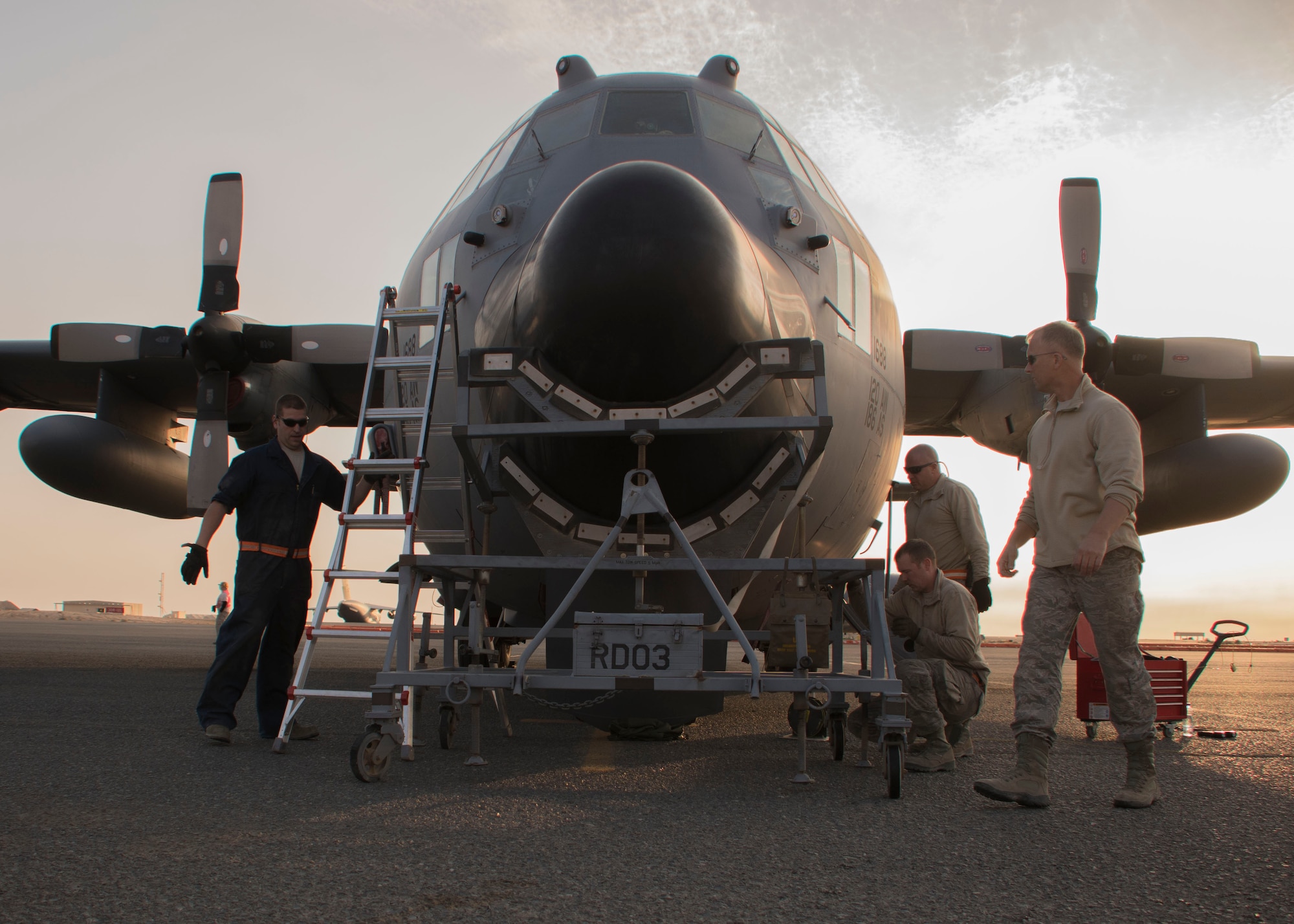 Members of the 386th Expeditionary Maintenance Squadron inspect a radome at an undisclosed location in Southwest Asia Jan. 4, 2017. The squadron received the new radome to replace one on a C-130H Hercules that was struck by lightning. (U.S. Air Force photo/Senior Airman Andrew Park)