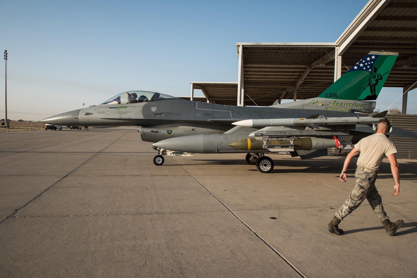 Staff Sgt. Larry Runk, 407th Expeditionary Maintenance Squadron crew chief, walks away from an F-16 Fighting Falcon assigned to the 134th Expeditionary Fighter Squadron after marshaling it for take off at the 407th Air Expeditionary Group, Dec. 29, 2016. Combat missions flown by the fighter squadron have degraded military capabilities of Daesh, also known as the Islamic State, by denying the group safe haven in the region. (U.S. Air Force photo/Master Sgt. Benjamin Wilson)(Released)