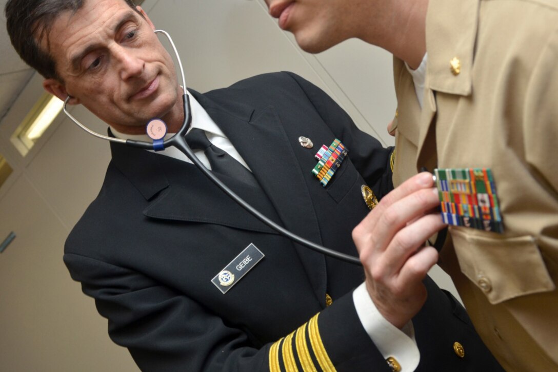 Navy Capt. Jesse Geibe, Naval Hospital Jacksonville director for public health, listens to a patient’s heart rate. The Jacksonville Business Journal honored Geibe as a 2016 Health Care Hero. Defense Department officials are reminding military and civilian employees that they must report their health care coverage to the Internal Revenue Service when they file their 2016 federal income tax form. Navy photo by Jacob Sippel
