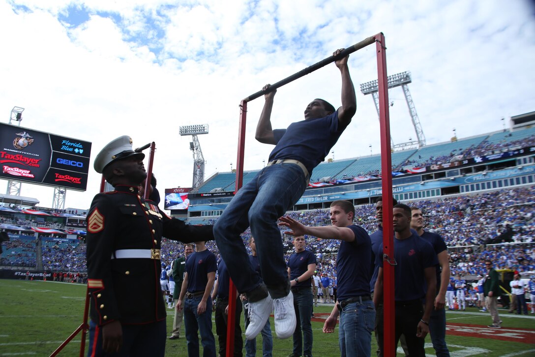 Future Marines participated in the pull up challenge monitored by Marines, on Dec. 31, 2016, at EverBank Field in Jacksonville, Florida. The pull up challenge took place during the TaxSlayer Bowl in front of Georgia Tech and the University of Kentucky fans. (U.S. Marine Corps photo by Lance Cpl. Jack A. E. Rigsby/Released)