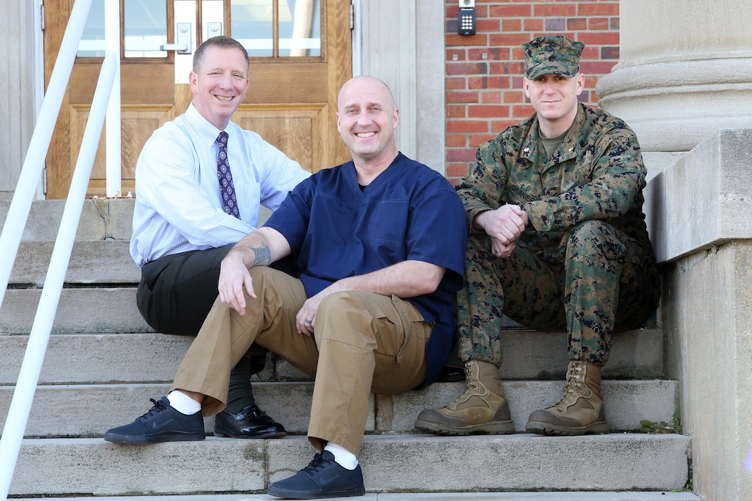 Joseph Klocek (left) and Maj. Scott Graniero (right) pose with Master Sgt. Clifford Farmer at Marine Corps Systems Command aboard Marine Corps Base Quantico, Va. Farmer credits the support and compassion of the two men—part of his leadership team at MCSC—with saving his life during a time when he contemplated suicide. Today, Farmer battles post-traumatic stress disorder and depression, and urges leaders across the Marine Corps to show understanding and compassion for Marines who may be suffering. 