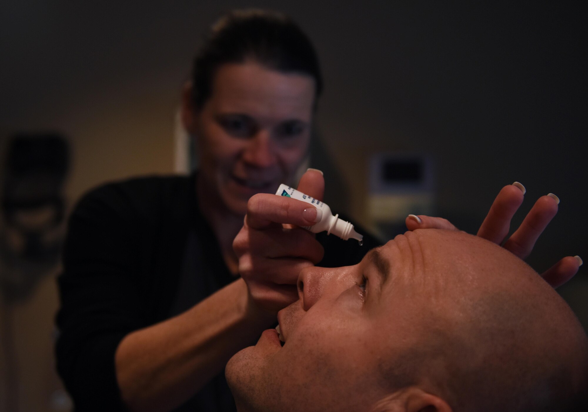 Patricia Hoogenveen, 19th Aerospace Medicine Squadron optometrist, applies eye drops to a patient during an ocular eye pressure test Dec. 19, 2016, at Little Rock Air Force Base, Ark. In addition to eye pressure tests, the optometry clinic offers services such as ordering glasses and preparing patients for refractive surgery. (U.S. Air Force photo by Senior Airman Mercedes Taylor)