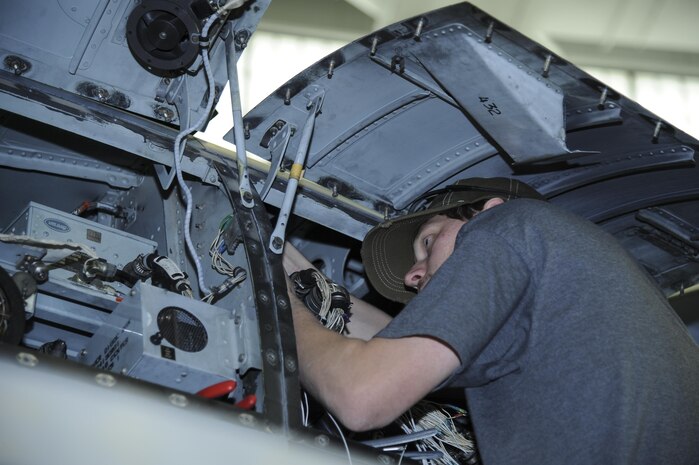 Aaron Miller, 309th Aircraft Maintenance and Regeneration Group aircraft technician, installs a wiring harness for a lightweight airborne recovery system into an A-10C Thunderbolt II at Davis-Monthan Air Force Base, Ariz., Dec. 5, 2016. The LARS V-12 is designed to allow A-10 pilots a more effective means of communication with individuals on the ground such as downed pilots, pararescuemen and joint terminal attack controllers. (U.S. Air Force photo by Airman 1st Class Mya M. Crosby)