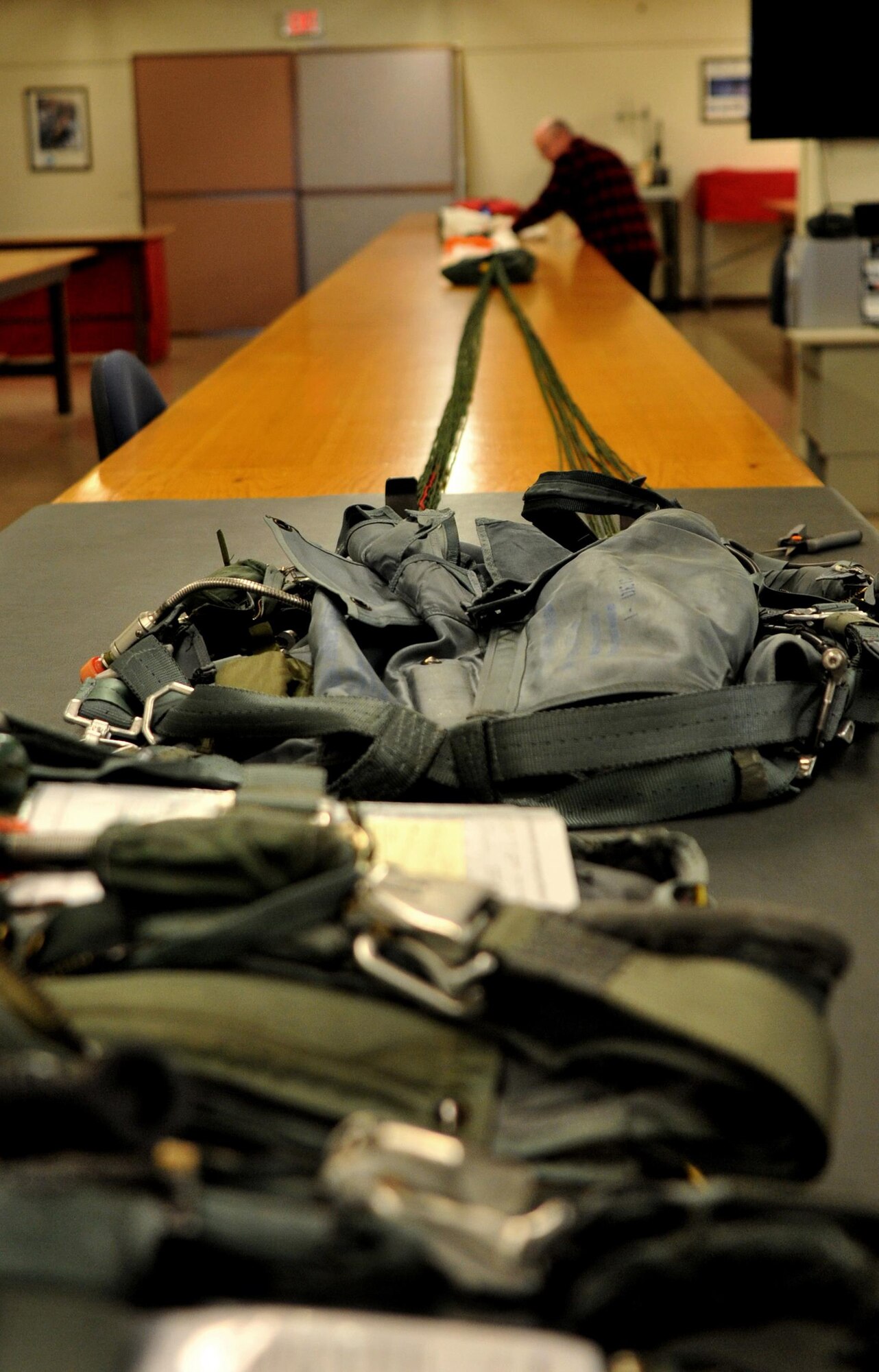Ray Conner, 9th Operational Support Squadron aircrew flight equipment craftsman unpacks a parachute Jan. 5, 2016, at Beale Air Force Base, California. Aircrew flight equipment is responsible for all of a pilot’s gear such as helmet, oxygen mask, harness and all life-saving devices. (U.S. Air Force photo/Staff Sgt. Jeffrey Schultze)