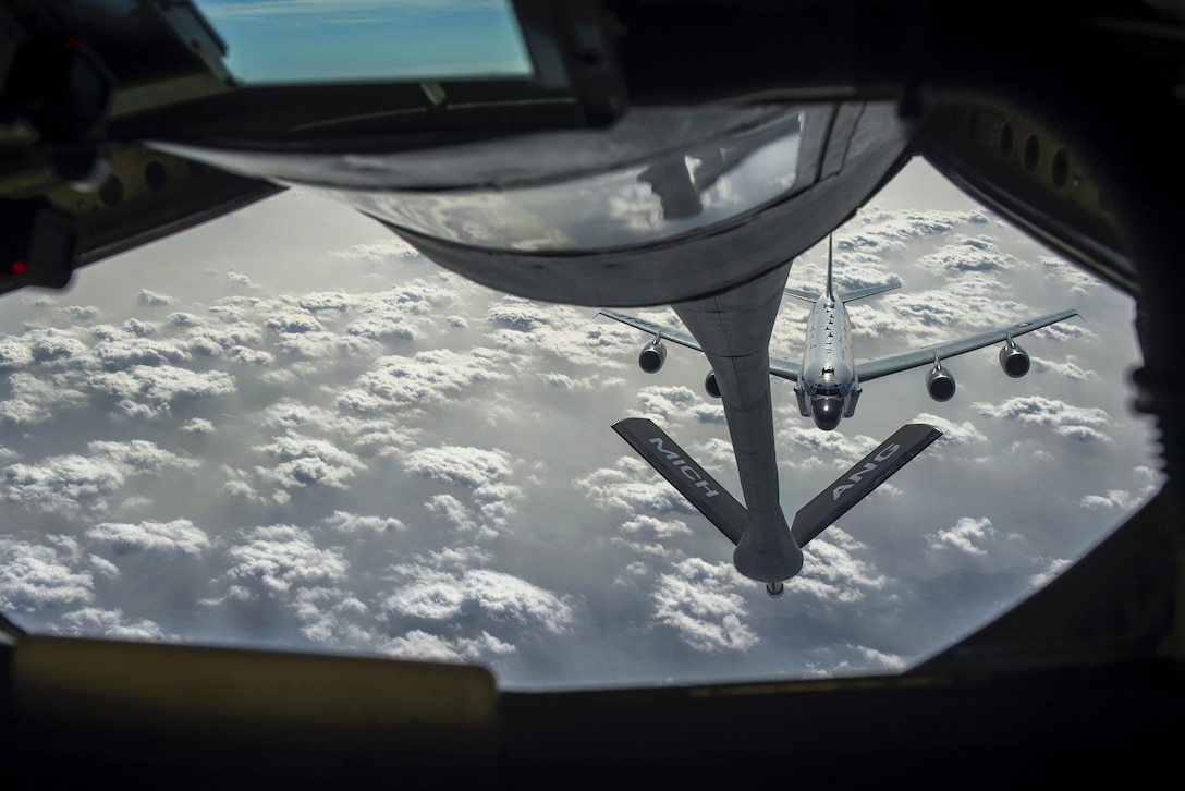 An Air Force RC-135 Rivet Joint reconnaissance aircraft is visible through the window of the boom operator's station aboard a KC-135 Stratotanker as it approaches for aerial refueling to support an Operation Freedom’s Sentinel mission over Afghanistan, Jan. 3, 2017. The 340th Expeditionary Air Refueling Squadron conducts tactical refueling operations, which extend capabilities across Southwest Asia. Air Force photo by Staff Sgt. Matthew B. Fredericks