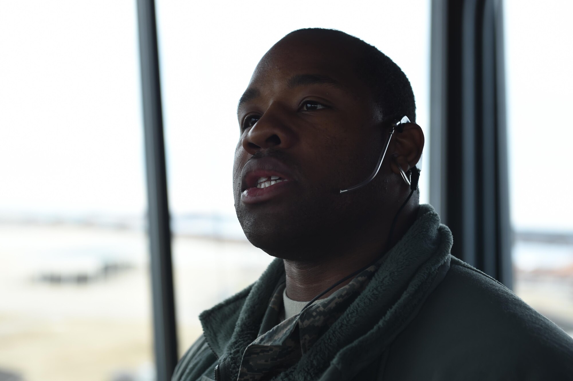 U.S. Air Force Senior Airman Chino Ross, 1st Operations Support Squadron air traffic controller, communicates with airfield members at Joint Base Langley-Eustis, Va., Dec. 16, 2016. The aircraft control tower supports approximately 30,000 missions annually and communicates with local flight facilities to coordinate safe air traffic. (U.S. Air Force photo by Staff Sgt. Natasha Stannard)