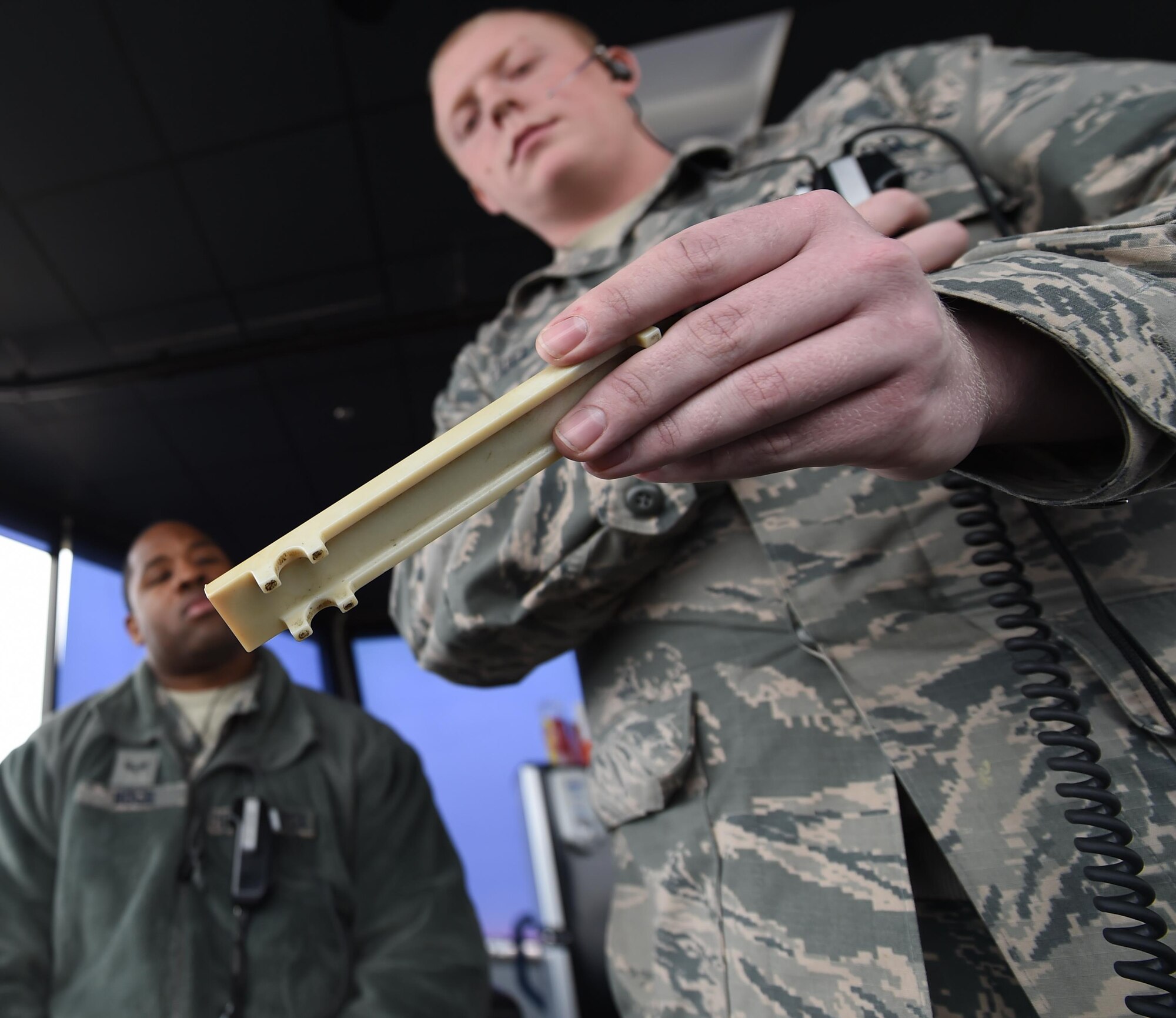 U.S. Air Force Senior Airman Chino Ross, left, and Senior Airman Patrick Taylor, 1st Operations Support Squadron air traffic controllers, review a flight strip at Joint Base Langley-Eustis, Va., Dec. 16, 2016. Flight strip information is sent from either Langley Air Force Base operations or the Norfolk Radar Center. (U.S. Air Force photo by Staff Sgt. Natasha Stannard)