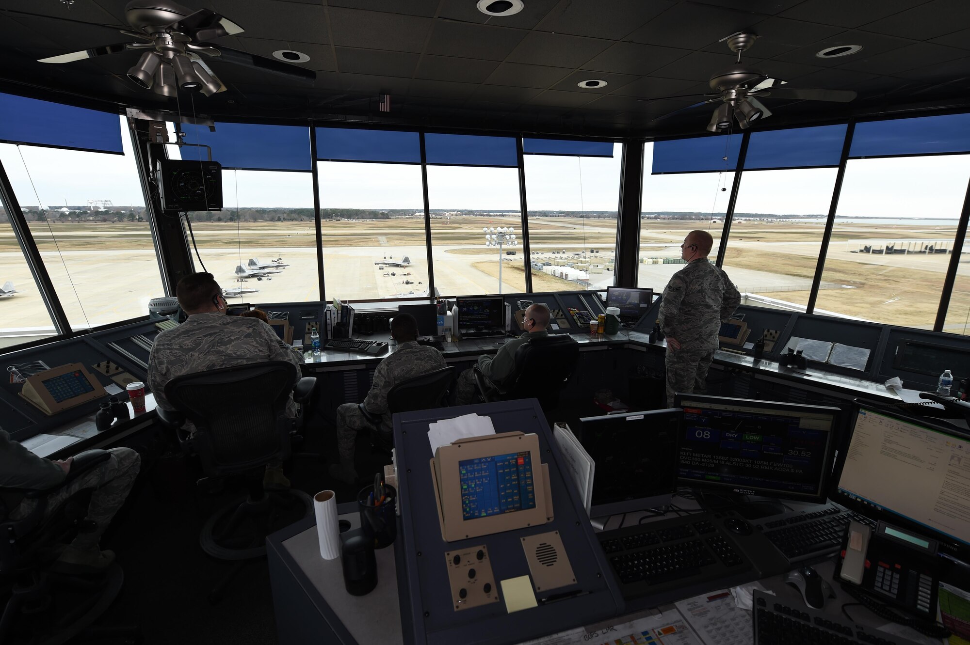 U.S. Air Force Airmen with the 1st Operations Support Squadron man the 1st Fighter Wing air traffic control tower at Joint Base Langley-Eustis, Va., Dec. 16, 2016. Controllers track the departure and arrival times and locations of aircraft, as well as when aircraft are airborne. (U.S. Air Force photo by Staff Sgt. Natasha Stannard)
