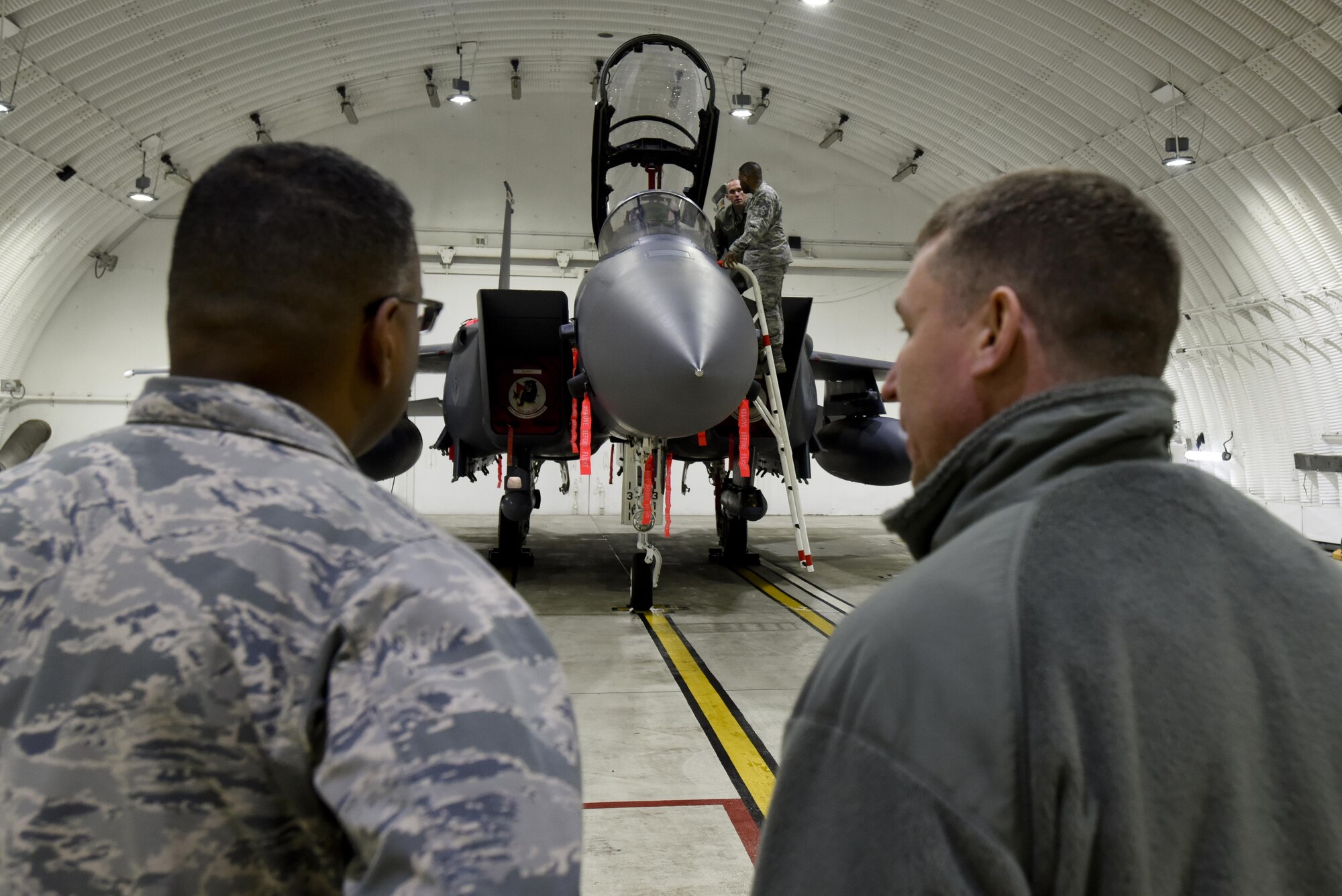 U.S. Air Force Lt. Gen. Richard Clark, 3rd Air Force commander, left, and Col. Evan Pettus, 48th Fighter Wing commander, converse in front of an F-15E Strike Eagle at Royal Air Force Lakenheath, England, Jan. 6. Clark and Chief Master Sgt. Phillip Easton, 3rd Air Force command chief, were participating in a base immersion tour. (U.S. Air Force photo/Airman 1st Class Eli Chevalier)