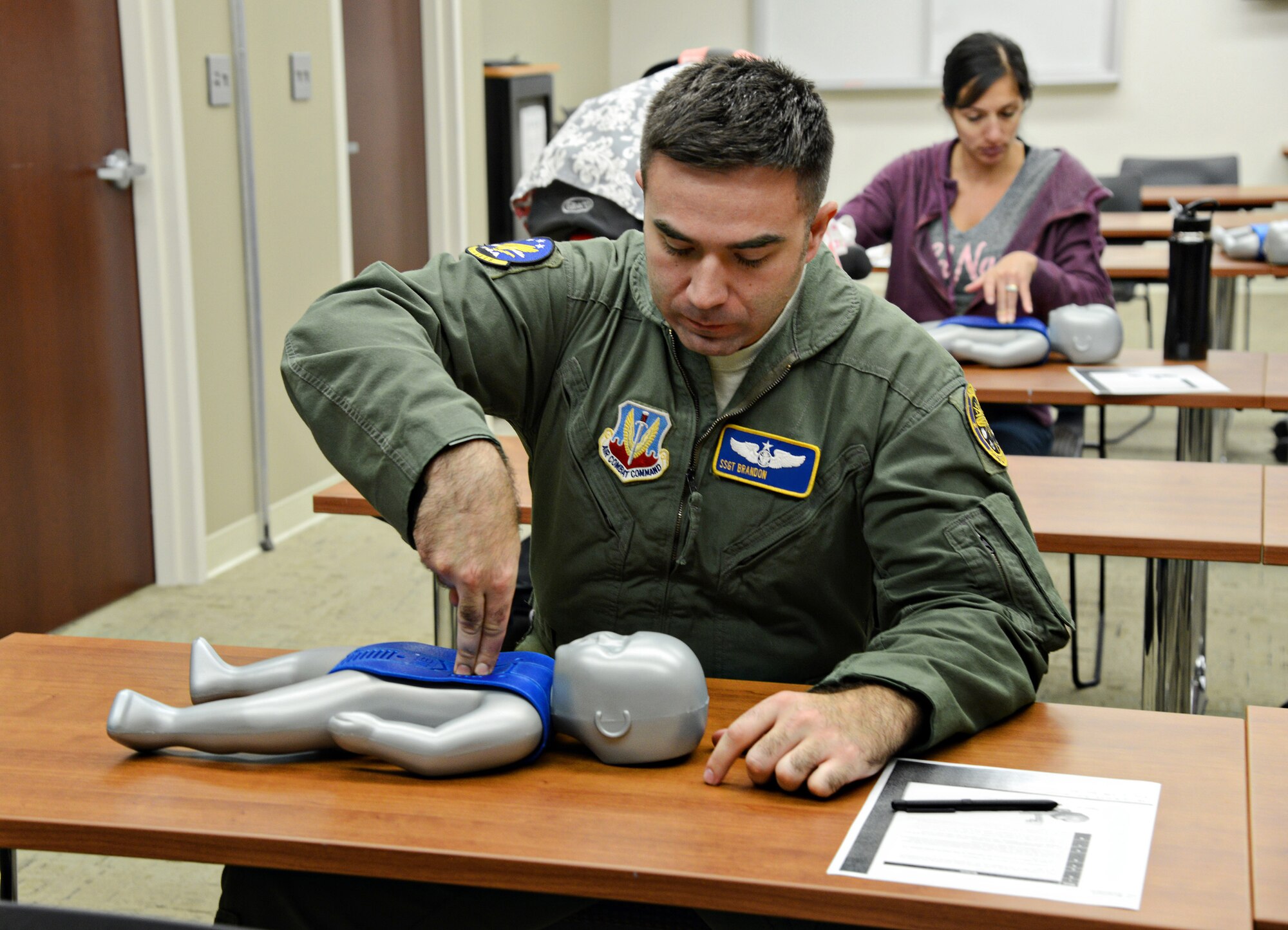 Staff Sgt. Brandon, with the 965th Airborne Air Control Squadron, and Traci Fuhrman, with the 72nd Force Support Squadron, practice CPR techniques on a baby dummy during a recent Infant and Child CPR class at the Tinker Clinic. The classes are held throughout the year. For more information or to enroll in a class, call Family Advocacy at 582-6604. (Air Force photo by Kelly White)