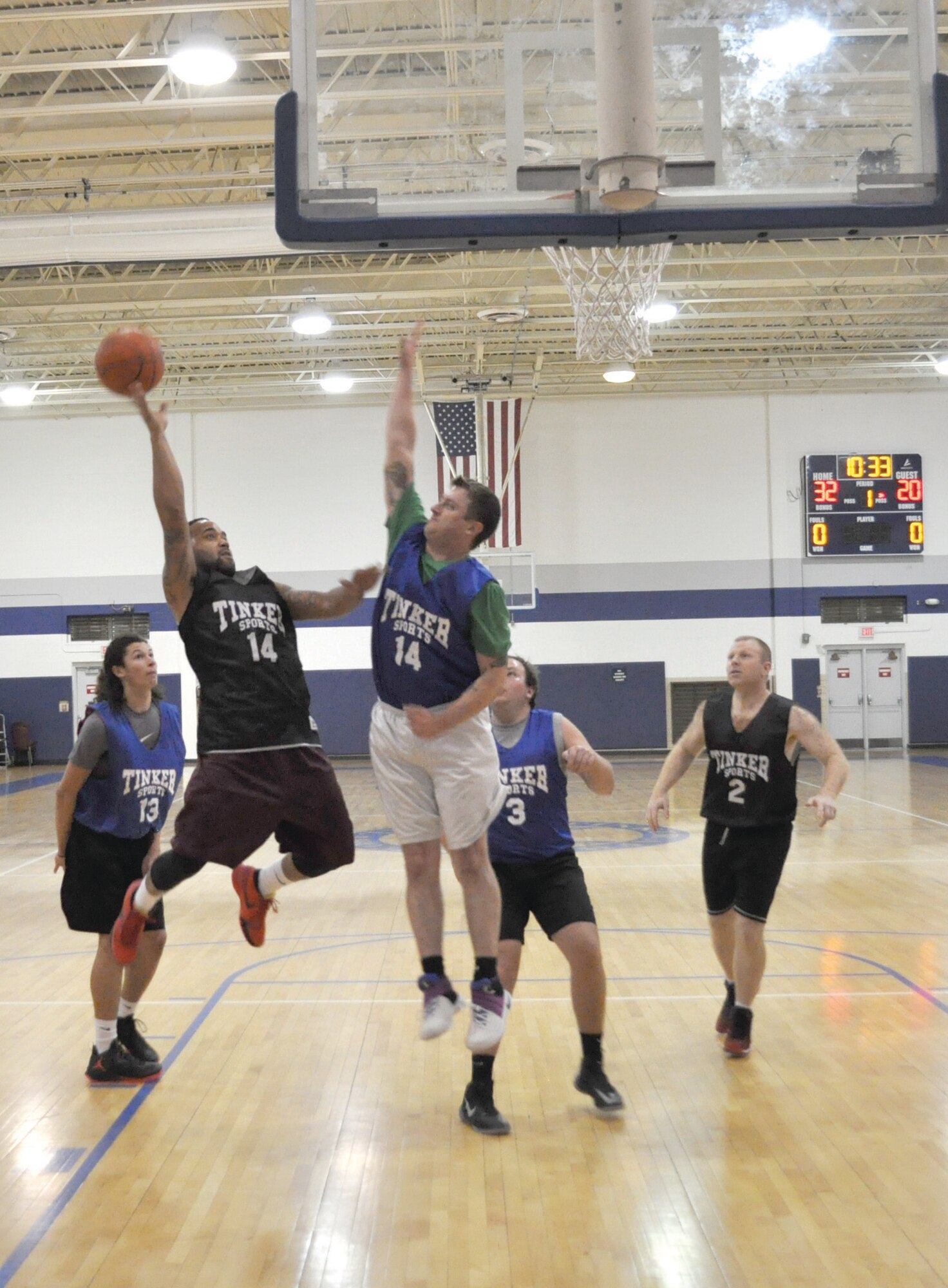 Contracting’s Jordan Pina fades back as he attempts to launch a shot over the defense of Timothy Cole, with the 72nd OSS team. Contracting convincingly overcame 72nd OSS 45-35 on Dec. 15. Intramural basketball restarted this week after the holiday hiatus. (Air Force photo by John Parker)