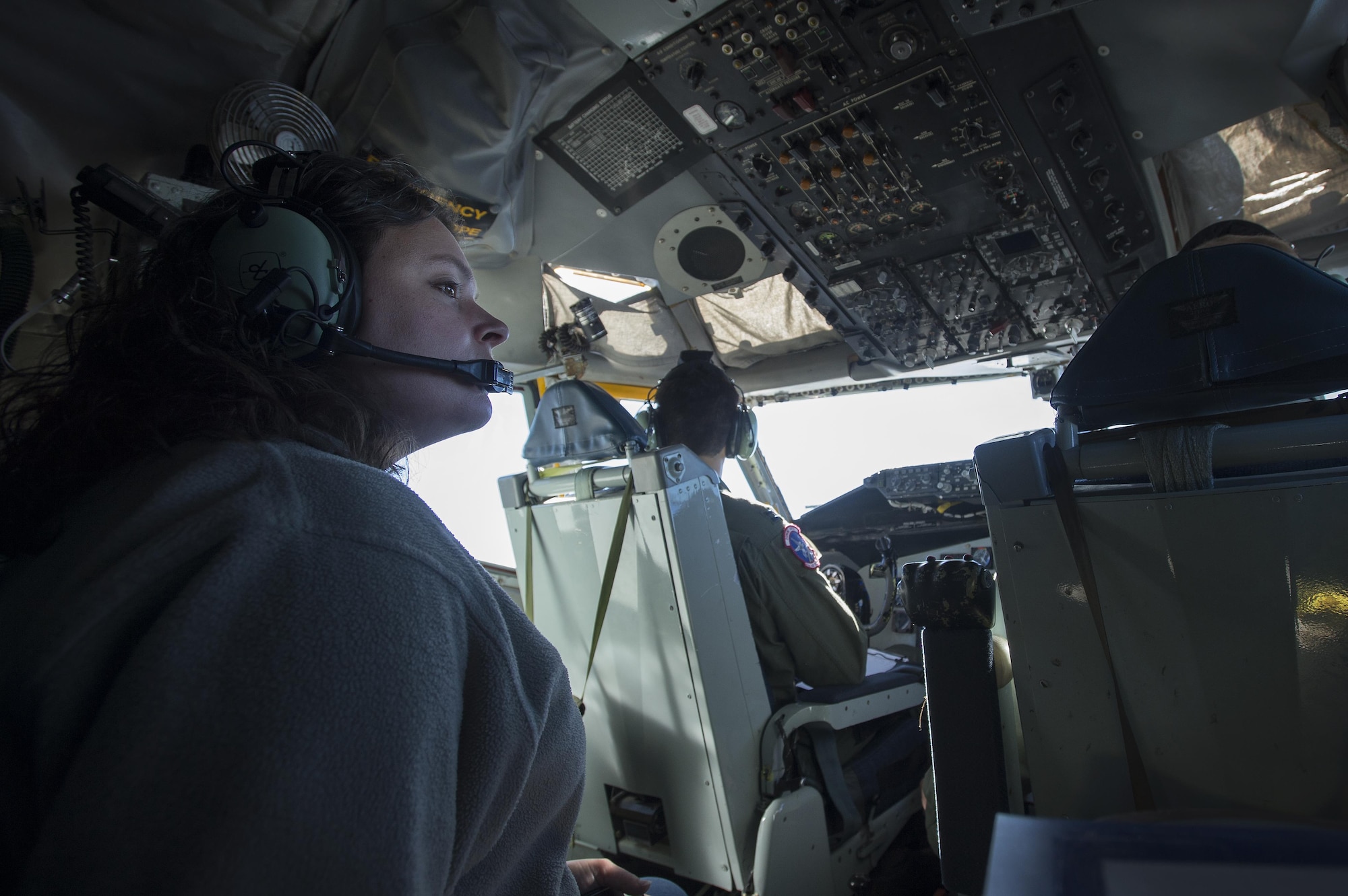 Emily Willhide, Team Shaw spouse, takes in the view from the cockpit of a KC-135 Stratotanker during a collaborative refueling training and spouse flight event at Shaw Air Force Base, S.C., Dec. 21, 2016. Airmen from the 93rd Air Refueling Squadron at Fairchild Air Force Base, Wash., brought the KC-135 to Shaw specifically for this training and utilized the ample space in both the cockpit and main cabin to take multiple Team Shaw spouses on a single spouse flight. (U.S. Air Force photo by Senior Airman Zade Vadnais)