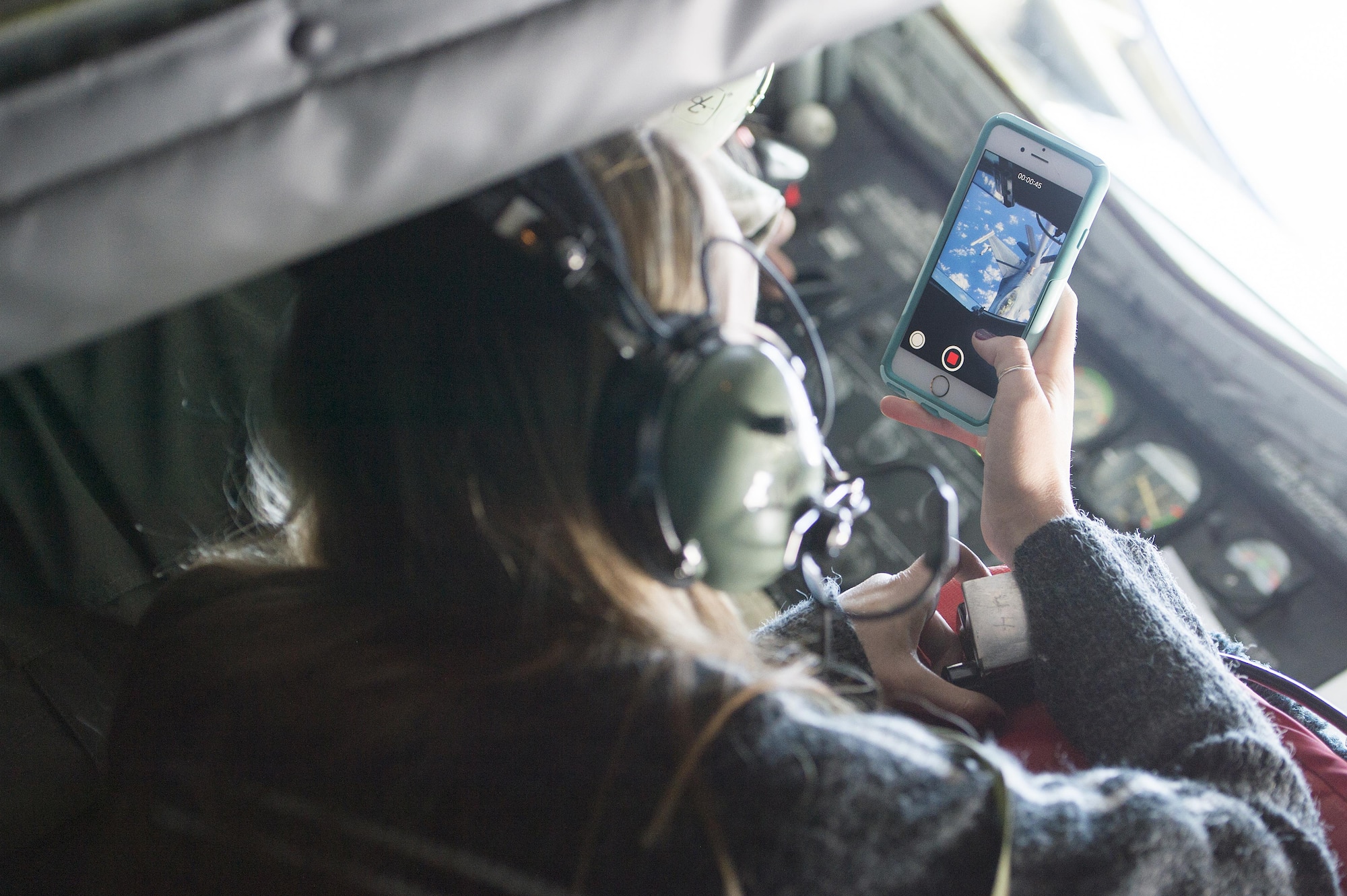 Sandra Vanta, a Team Shaw spouse, takes photos of her husband, Maj. Jason Vanta, 77th Fighter Squadron F-16CM Fighting Falcon pilot, as he refuels his jet from a KC-135 Stratotanker assigned to the 93rd Air Refueling Squadron from Fairchild Air Force Base, Wash., during a collaborative refueling training and spouse flight event over the Atlantic Ocean, Dec. 21, 2016. During the event, Team Shaw pilots were able to practice refueling procedures and their spouses were able to get a closer look at the job their husbands do every day. (U.S. Air Force photo by Senior Airman Zade Vadnais)