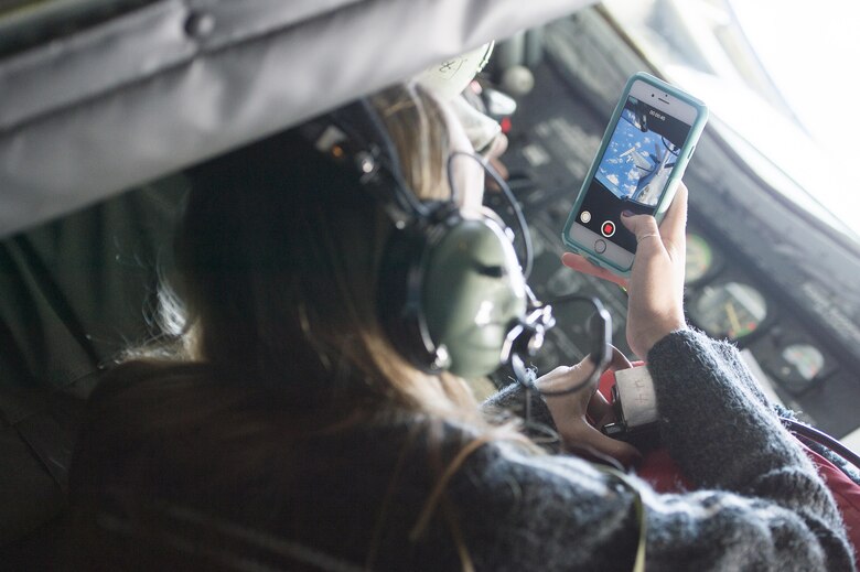 Sandra Vanta, a Team Shaw spouse, takes photos of her husband, Maj. Jason Vanta, 77th Fighter Squadron F-16CM Fighting Falcon pilot, as he refuels his jet from a KC-135 Stratotanker assigned to the 93rd Air Refueling Squadron from Fairchild Air Force Base, Wash., during a collaborative refueling training and spouse flight event over the Atlantic Ocean, Dec. 21, 2016. During the event, Team Shaw pilots were able to practice refueling procedures and their spouses were able to get a closer look at the job their husbands do every day. (U.S. Air Force photo by Senior Airman Zade Vadnais)