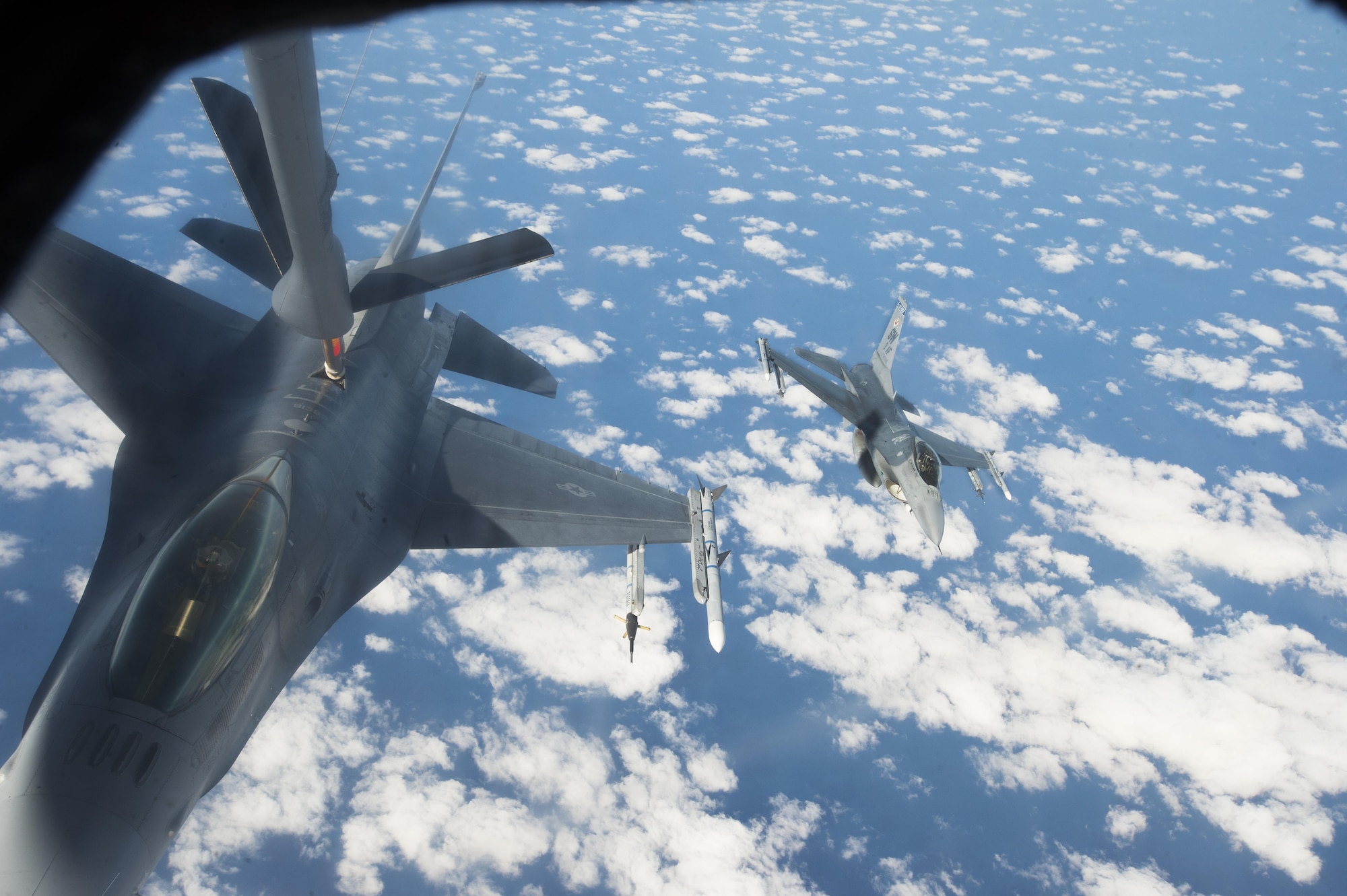A U.S. Air Force F-16CM Fighting Falcon assigned to the 20th Fighter Wing refuels from a KC-135 Stratotanker assigned to the 93rd Air Refueling Squadron from Fairchild Air Force Base, Wash., as another Team Shaw F-16 approaches over the Atlantic Ocean, Dec. 21, 2016. Airmen from the 93rd RS spent a week at Shaw for collaborative refueling training, giving Team Shaw F-16 pilots the opportunity to practice refueling procedures under various conditions. (U.S. Air Force photo by Senior Airman Zade Vadnais)