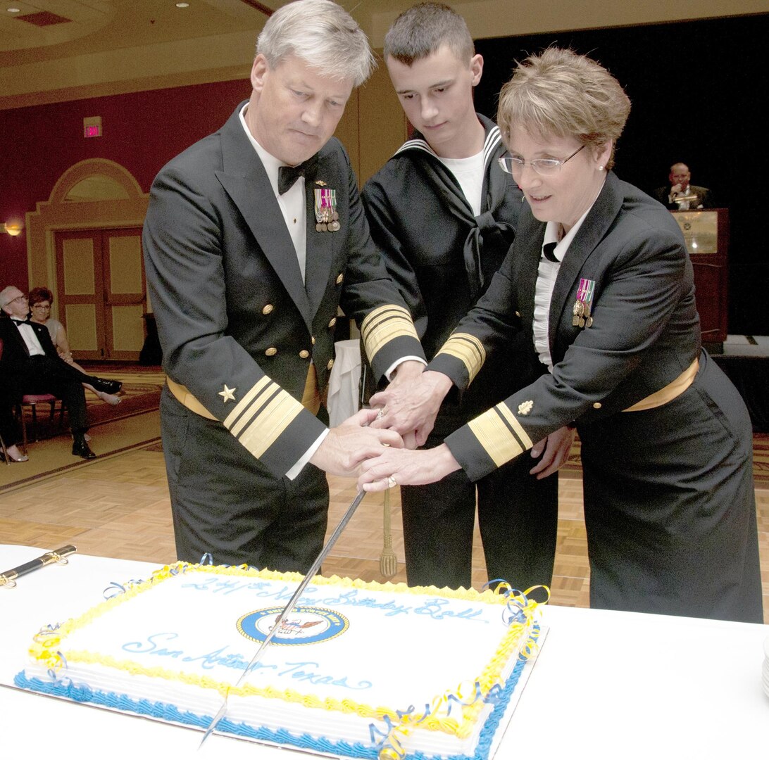 Vice Adm. Robert L. Thomas Jr. (left), Director, Navy Staff, and Rear Adm. Rebecca McCormick-Boyle, (right), commander, Navy Medicine Education and Training Command at Joint Base San Antonio-Fort Sam Houston, cut the cake along with the youngest Sailor in attendance at the annual San Antonio Navy Ball at the Omni San Antonio Hotel in San Antonio Oct. 15.