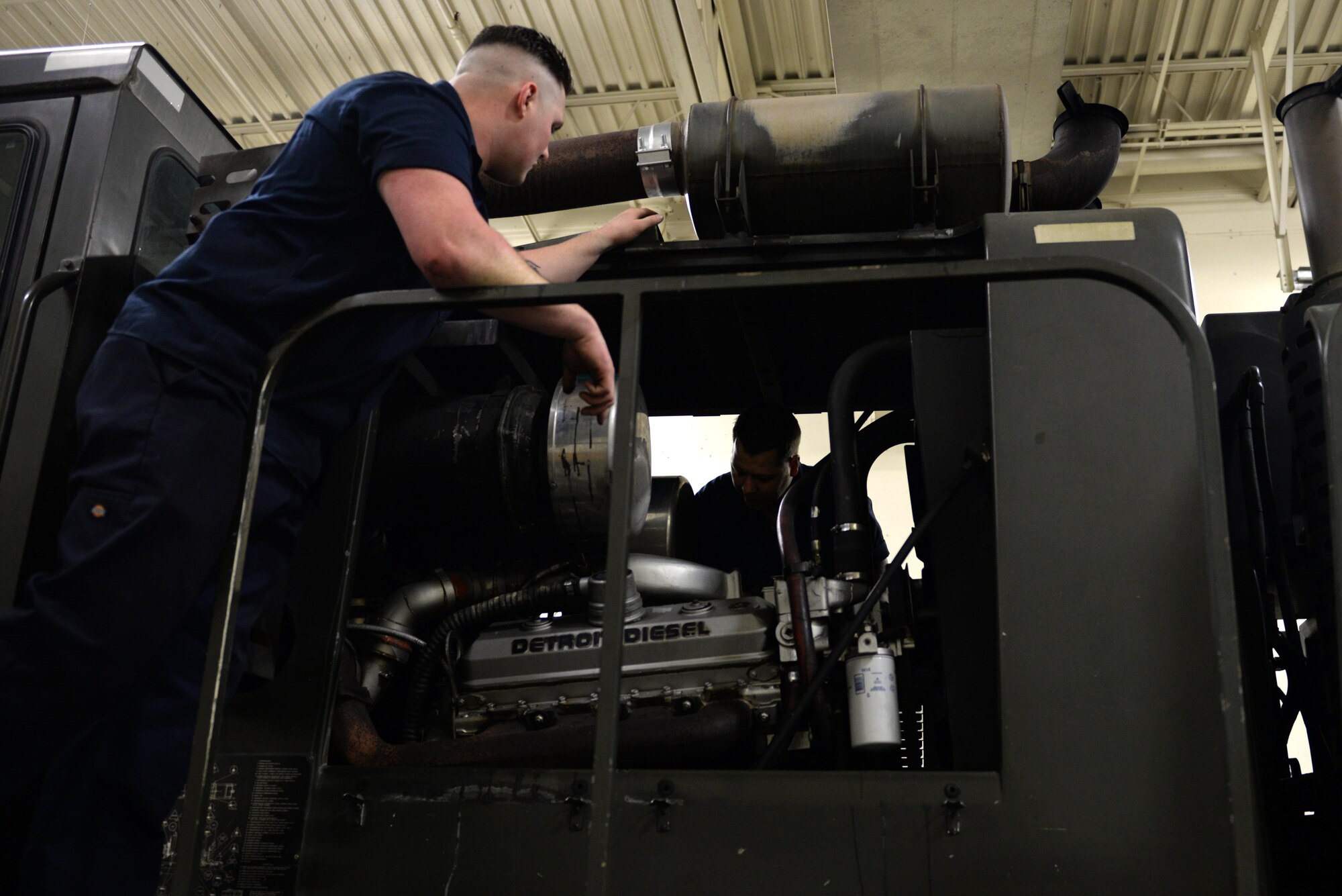 U.S. Air Force Senior Airman Dakota Greenwade, a 354th Logistics Readiness Squadron (LRS) vehicle maintenance technician, consults Staff Sgt. Robert Sommerfeldt, a 354th LRS vehicle maintenance technician during a diagnostic engine test Jan. 6, 2017, at Eielson Air Force Base, Alaska. Sommerfeldt and Greenwade looked for wires and labels to figure out exactly what is wrong with the snow grater. (U.S. Air Force photo by Airman 1st Class Cassandra Whitman)