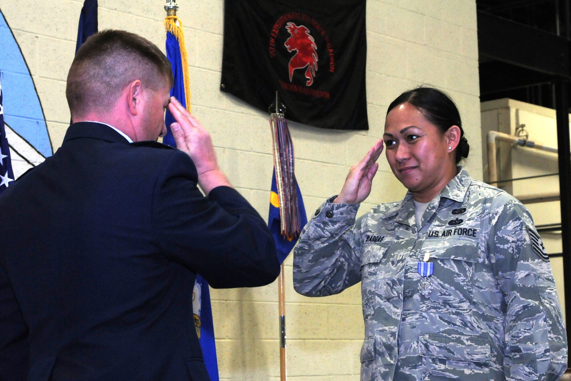 Tech. Sgt. Rhoda Bargas, 219th Rapid Engineering, Deployable, Heavy Operational Repair Squadron Engineer, or RED HORSE Squadron member, salutes 219th RHS Commander, Lt. Col. Rusty Vaira after receiving the Air Force Achievement medal for deployed operations Dec. 4, 2016. The 219th RED HORSE deployed in support of operations Inherent Resolve and Freedom’s Sentinel.(U.S. Air National Guard photo/Staff Sgt. Lindsey Soulsby)