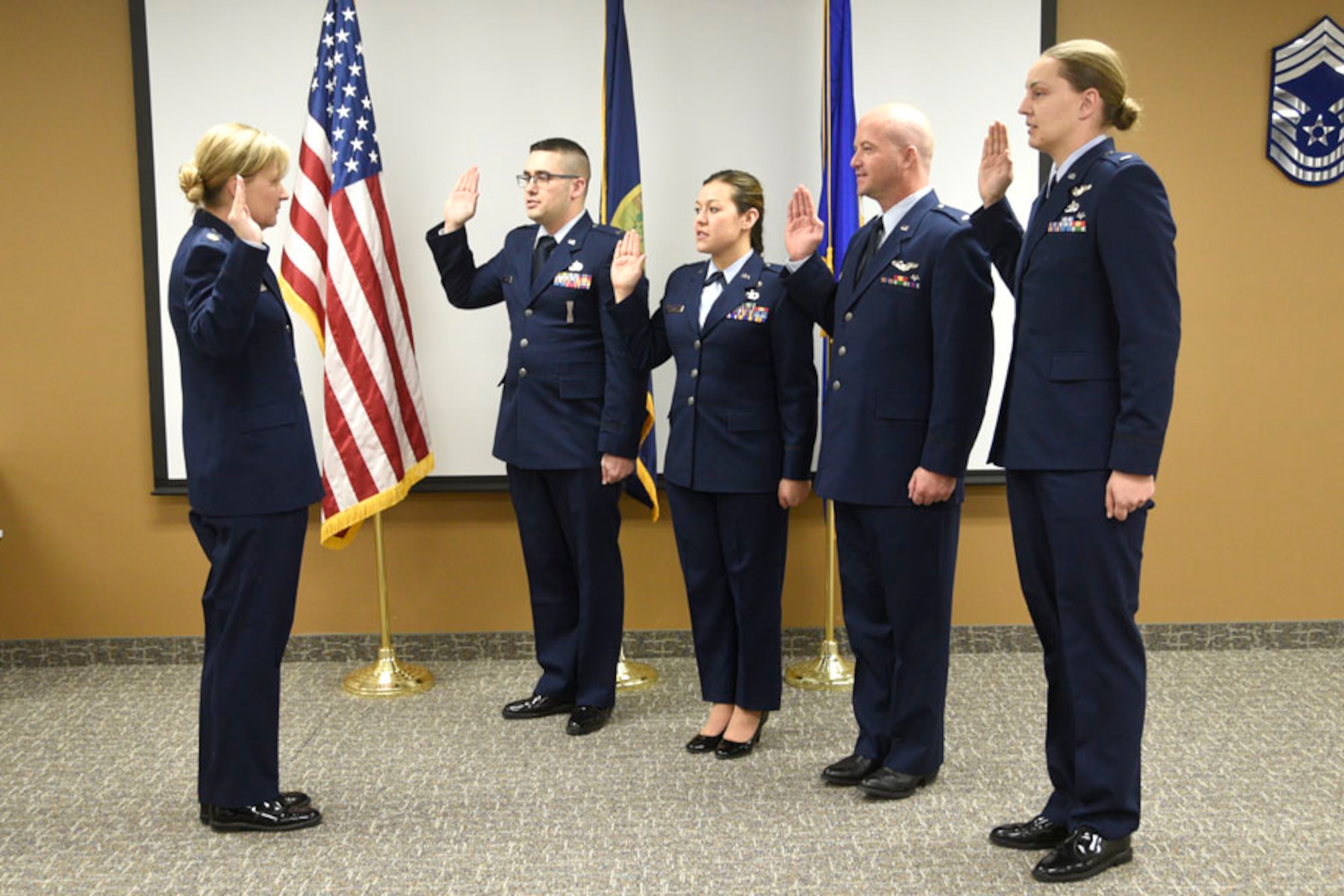 120th Airlift Wing Executive Officer Maj. Maureen Maphies administers oaths to 1st Lts. Bradley J. Gauvin, Caressa L. Hewitt, Raymond R. Orsua and Cassandra L. Ross during a promotion ceremony held on base Dec. 16, 2016. (U.S. Air National Guard photo/Senior Master Sgt. Eric Peterson)