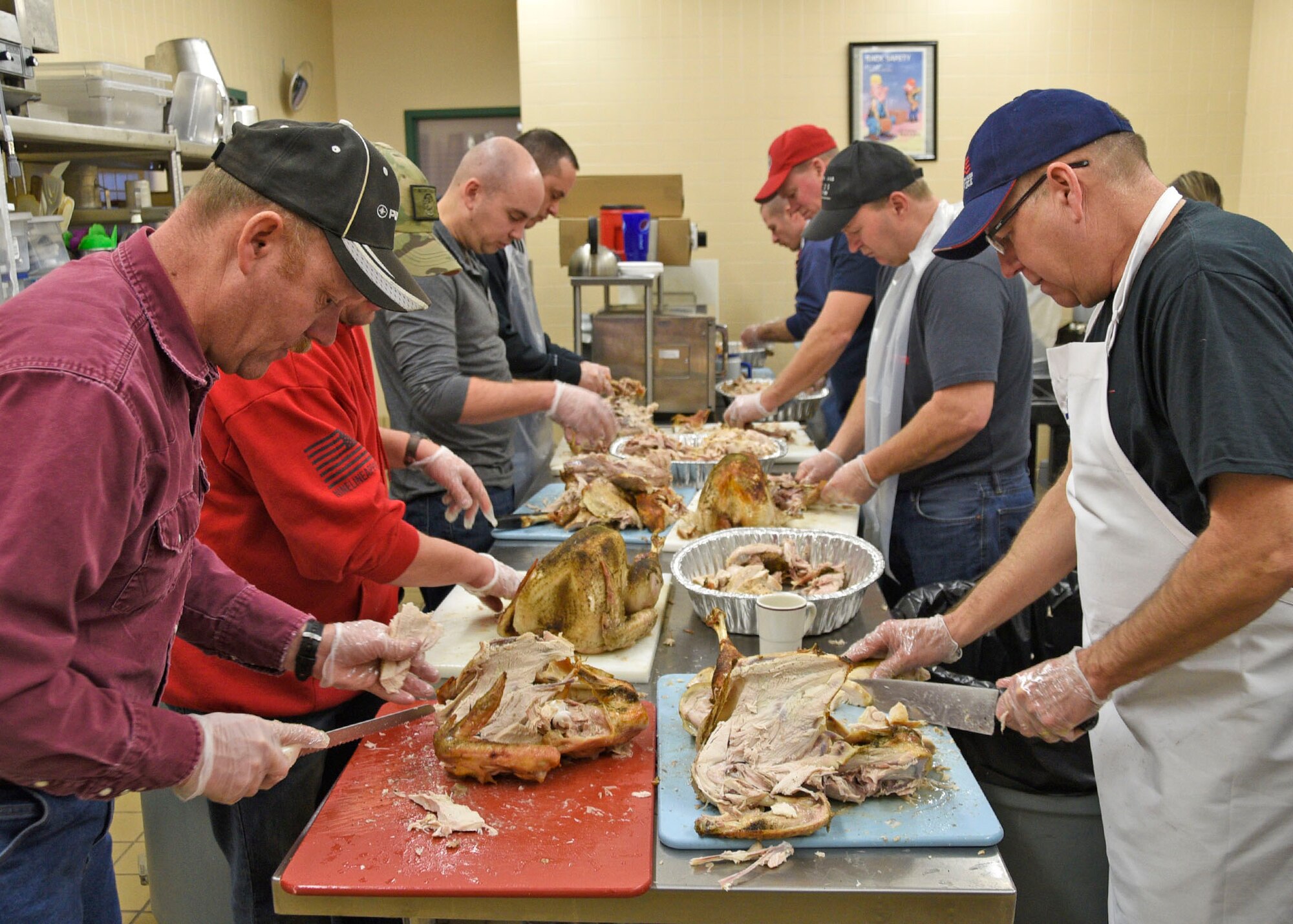 Volunteers from the Montana Air National Guard carve turkeys on Christmas Eve to be served at the 24th annual Danny Berg Memorial Christmas Dinner. This year 50 turkeys were cooked at the 120th Airlift Wing's Dining Facility for the community meal hosted at the Great Falls Senior Citizens Center. (U.S. Air National Guard photo by Senior Master Sgt. Eric Peterson/Released)