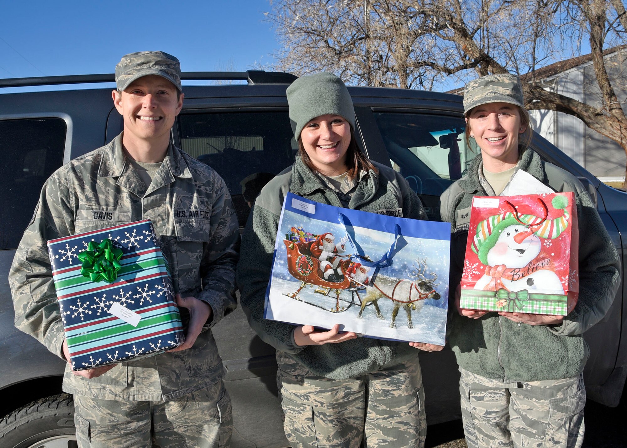 120th Communications Flight members Tech. Sgt. Kenneth Davis, Staff Sgt. Holly Dixon and Senior Airman Leslie Osterman volunteered to deliver packages for the Cascade County Meals on Wheels program as a community service project during the holiday season in Great Falls, Mont. Dec. 21, 2016. (U.S. Air National Guard photo by Senior Master Sgt. Eric Peterson/Released)