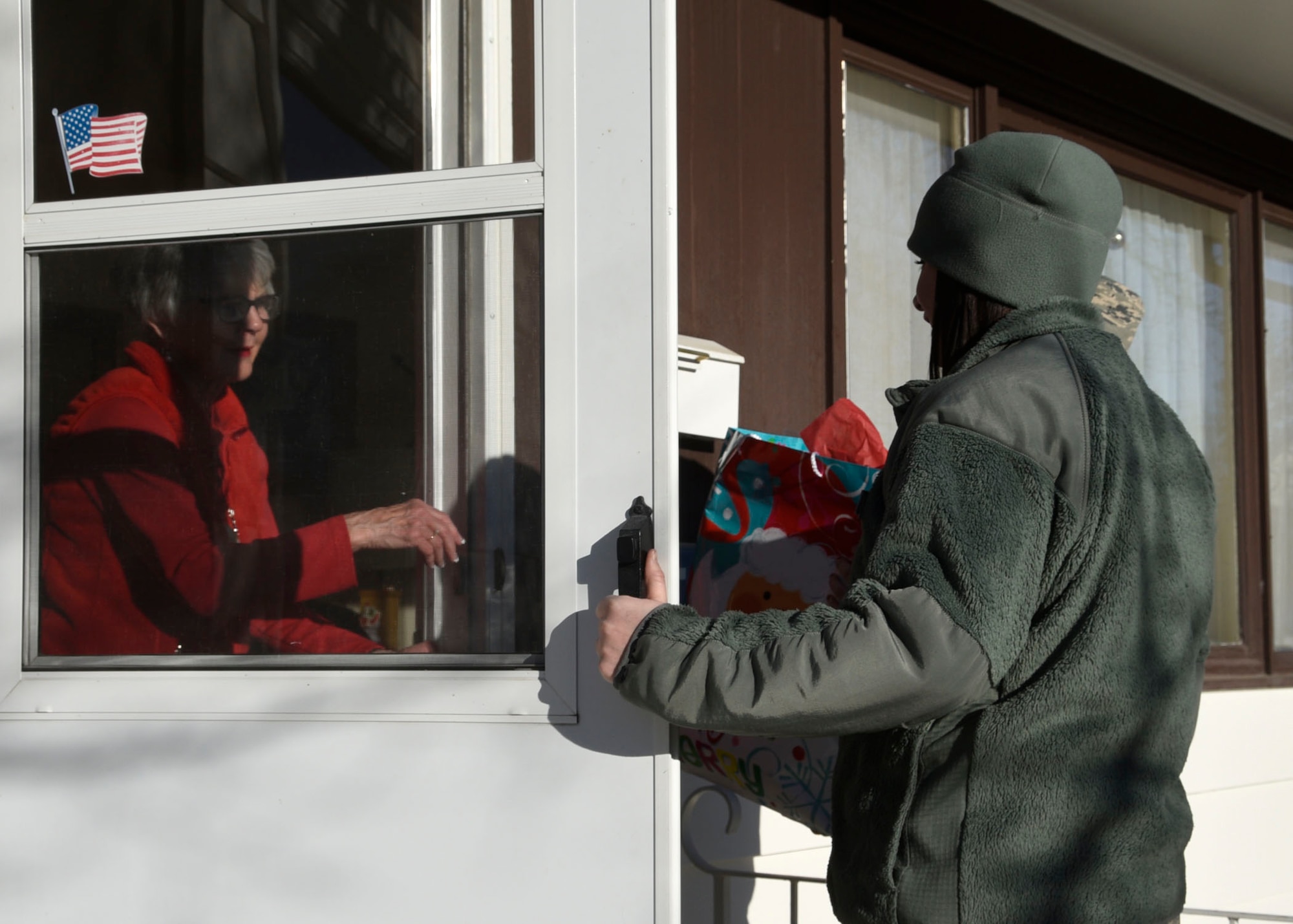 Communications Flight members Senior Airman Leslie Osterman and Staff Sgt. Holly Dixon volunteered to deliver packages for the Cascade County Meals on Wheels program as a community service project during the holiday season in Great Falls, Mont. Dec. 21, 2016. (U.S. Air National Guard photo by Senior Master Sgt. Eric Peterson/Released)