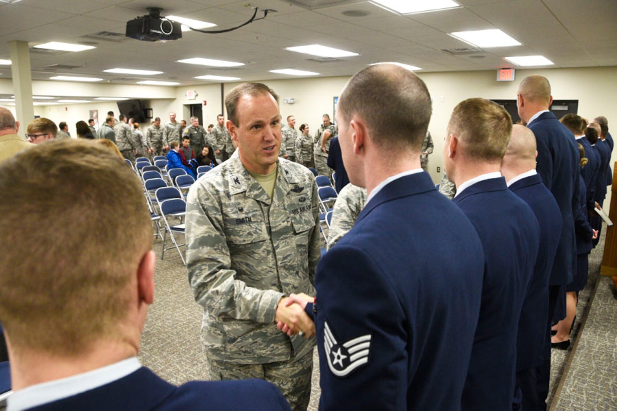 120th Airlift Wing Commander Col. Lee Smith congratulates Staff Sgt. Alexander Jorgenson following the 120th AW NCO Induction Ceremony held on base in Great Falls, Mont. Dec. 4, 2016. (U.S. Air National Guard photo/Senior Master Sgt. Eric Peterson)