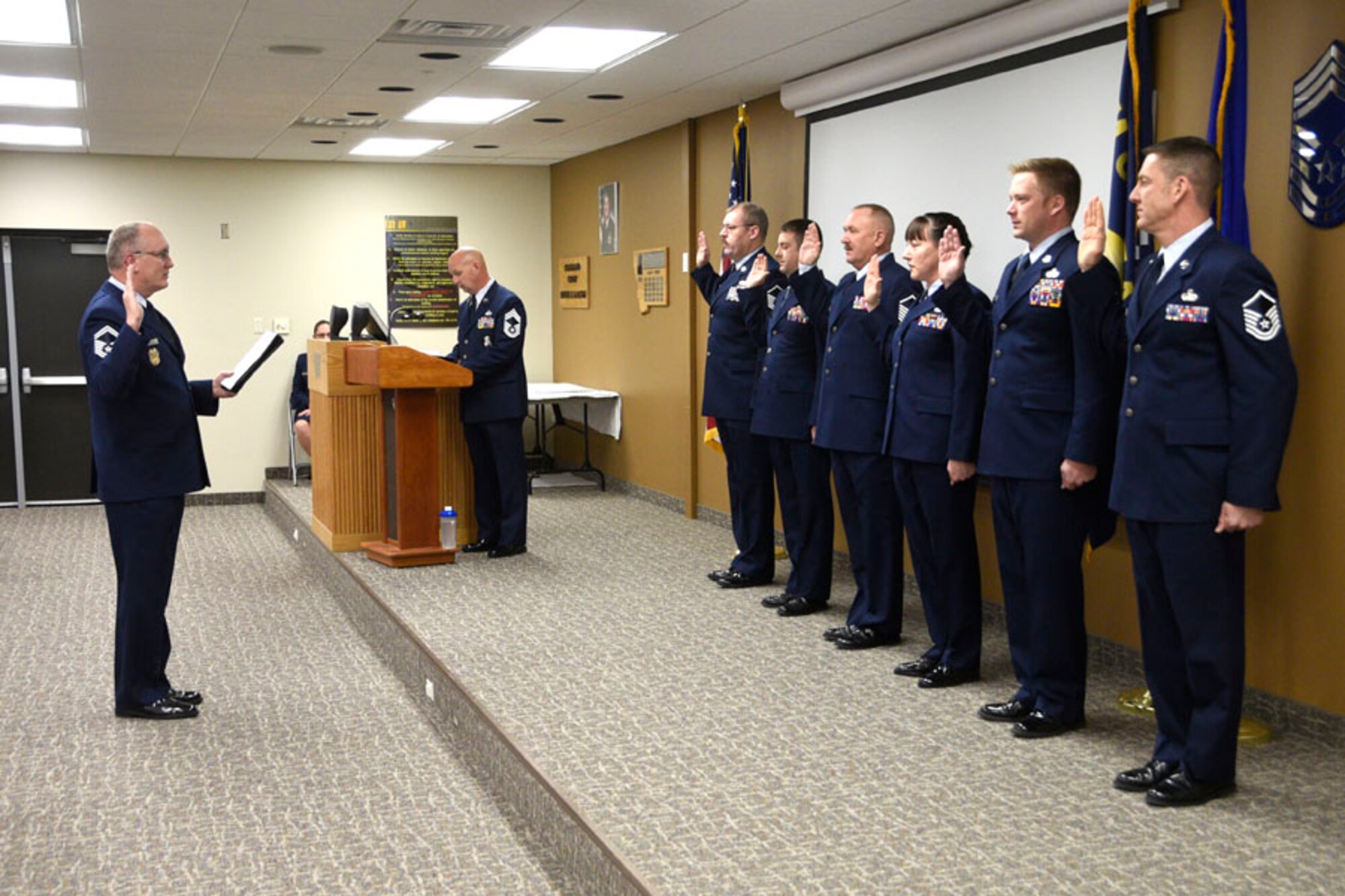 Newly promoted master sergeants take the oath administered by Senior Master Sgt. Bill Shirley during the Senior NCO Induction Ceremony held at the 120th Airlift Wing in Great Falls, Mont. Dec. 4, 2016. (U.S. Air National Guard photo/Senior Master Sgt. Eric Peterson)