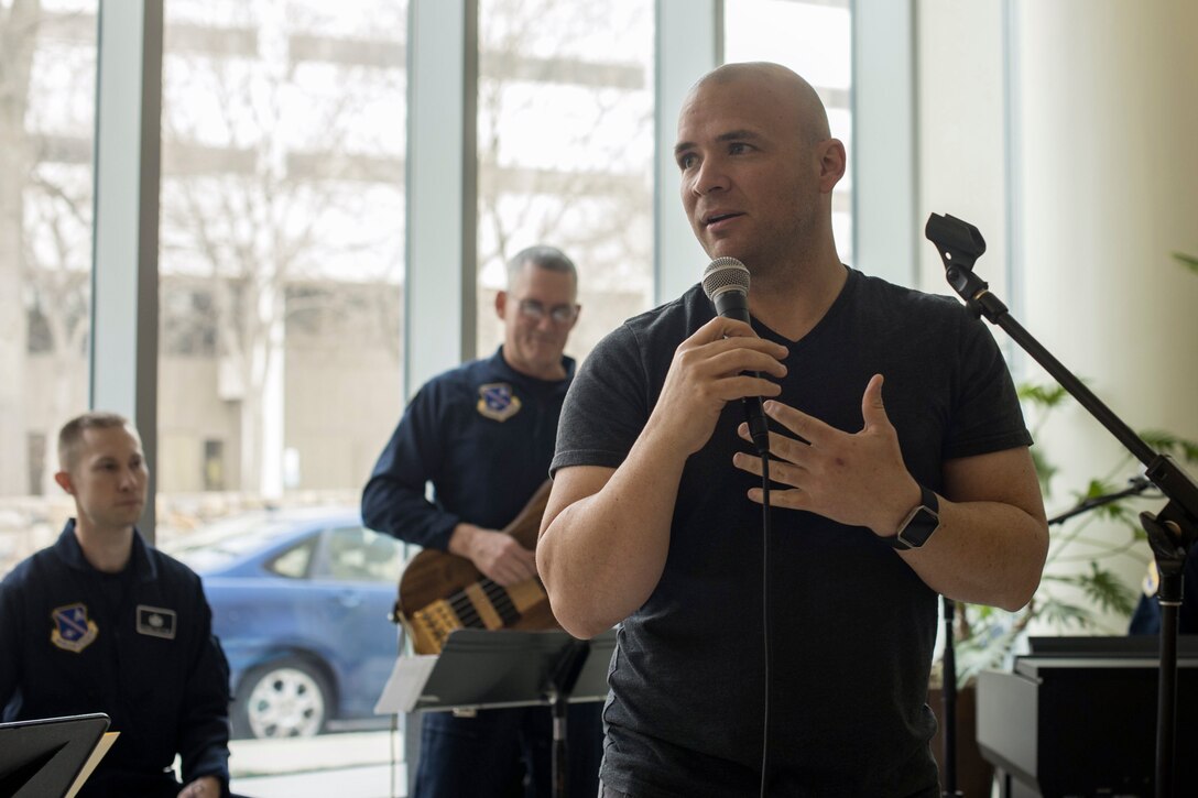 U.S. Army Sgt. Andrew Bell, National Intrepid Center of Excellence patient, speaks to the audience before a performance at Walter Reed National Military Medical Center in Bethesda, Md., Dec. 13, 2016. U.S. Air Force Band Max Impact accompanied Bell as he performed “The Christmas Song” at the NICoE Creative Arts Café. NCAC is performance platform for NICoE patients and staff to share creativity though creative arts once a month. (U.S. Air Force photo by Airman 1st Class Rustie Kramer)