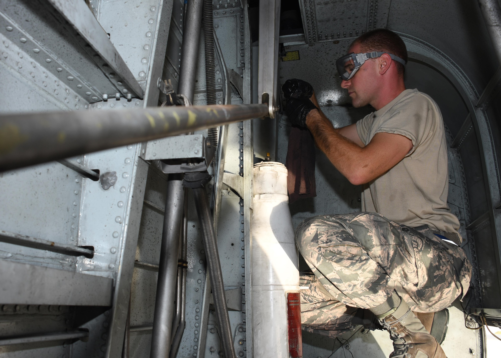 U.S. Air Force Staff Sgt. James Swann, a crew chief with the 379th Expeditionary Aircraft Maintenance Squadron, 746th Expeditionary Aircraft Maintenance Unit, applies lubricant to the landing gear of a C-130 Hercules at Al Udeid Air Base, Qatar, Dec. 30, 2016. The landing gear on each C-130 is lubricated every 15 days due to frequent use. (U.S. Air Force photo by Senior Airman Miles Wilson)
