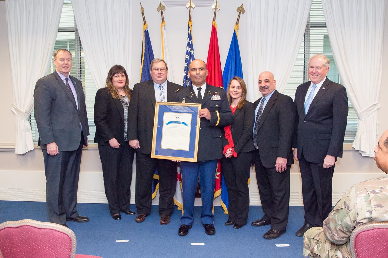 Deputy Secretary of Defense Bob Work and Under Secretary of Defense for Acquisition, Technology and Logistics Frank Kendall stand with the Project Manager Maneuver Ammunition Systems winner of the David Packard Excellence in Acquisitions Award, at the Pentagon in Washington, D.C., Jan. 6, 2017. DoD photo by Army Sgt. Amber I. Smith